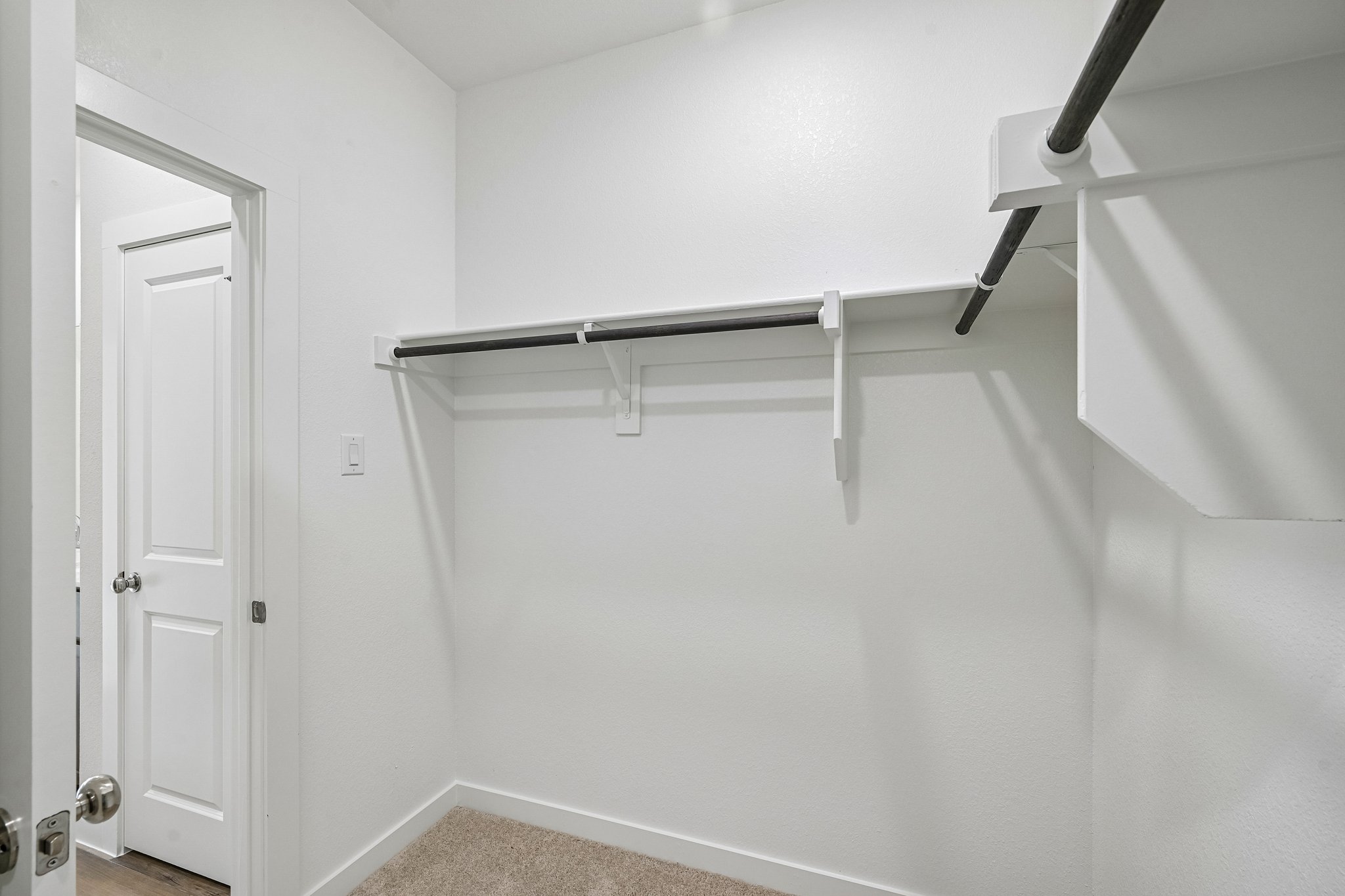 A white staircase with a white door.