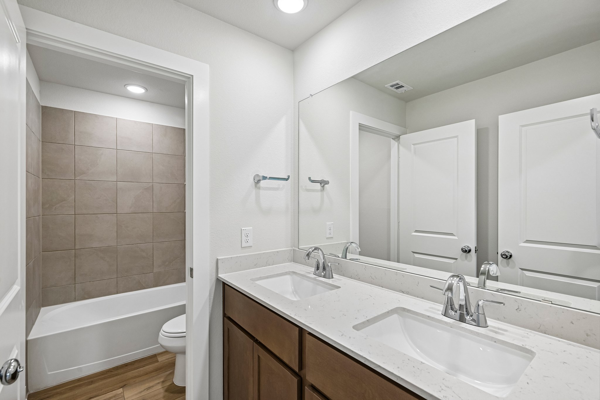 A bathroom with a tub sink and toilet.