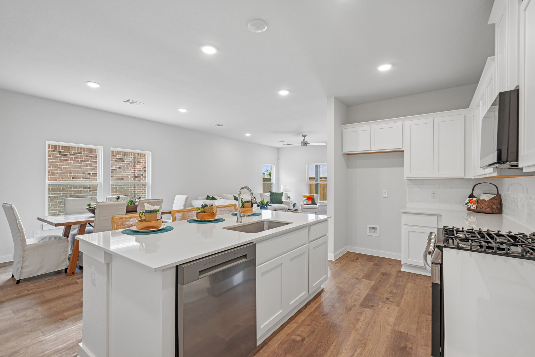 A kitchen with white cabinets.