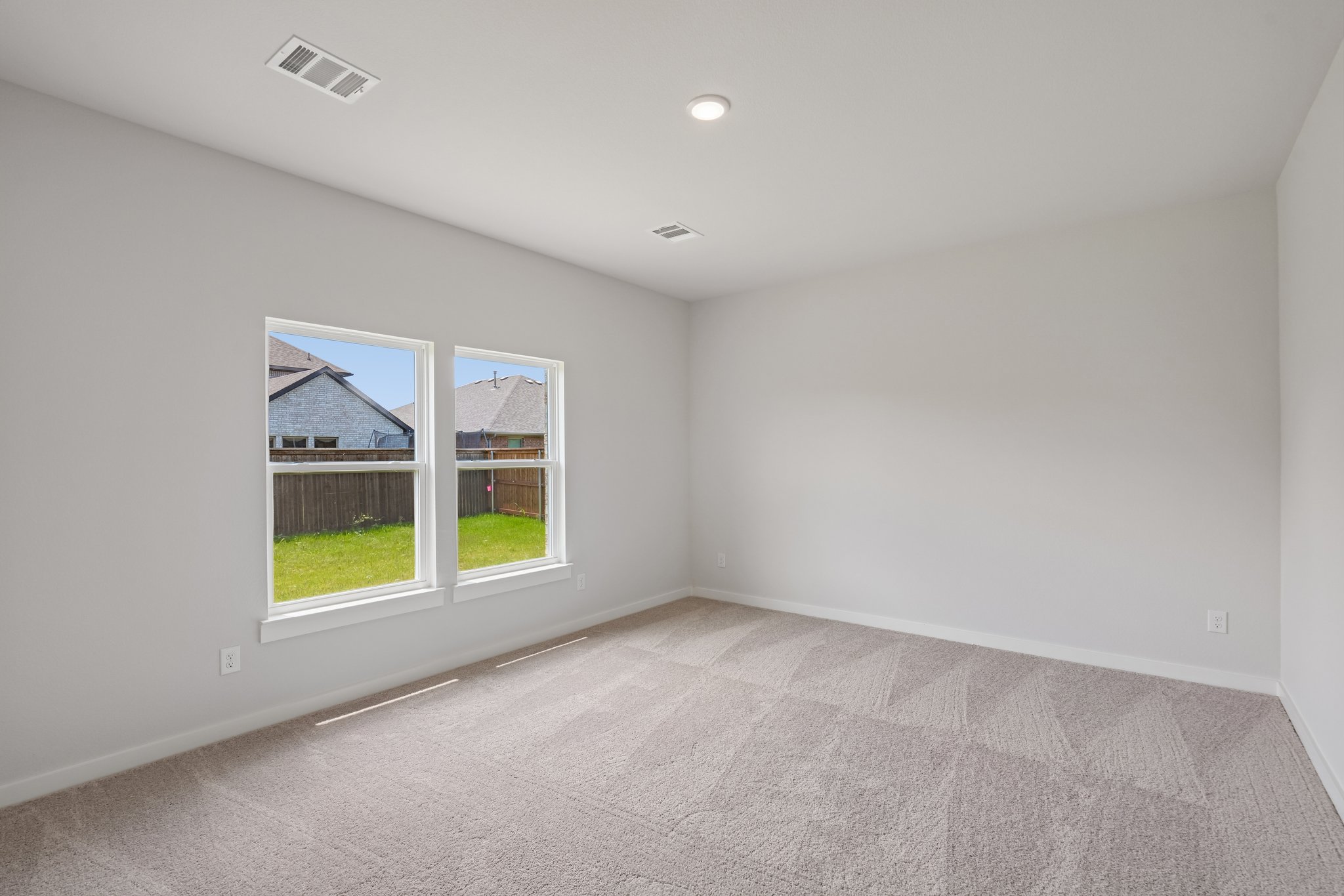 A room with a window and a carpet.