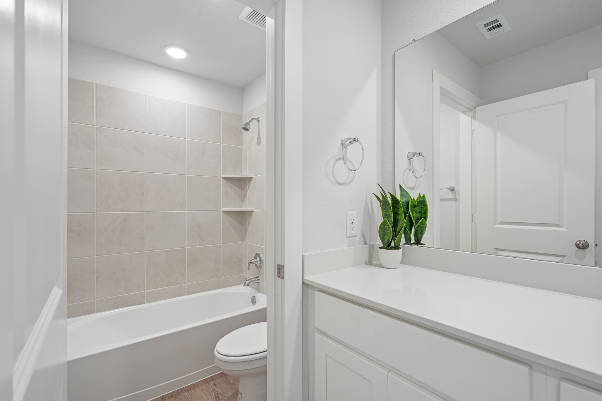 A bathroom with a tub toilet and sink.
