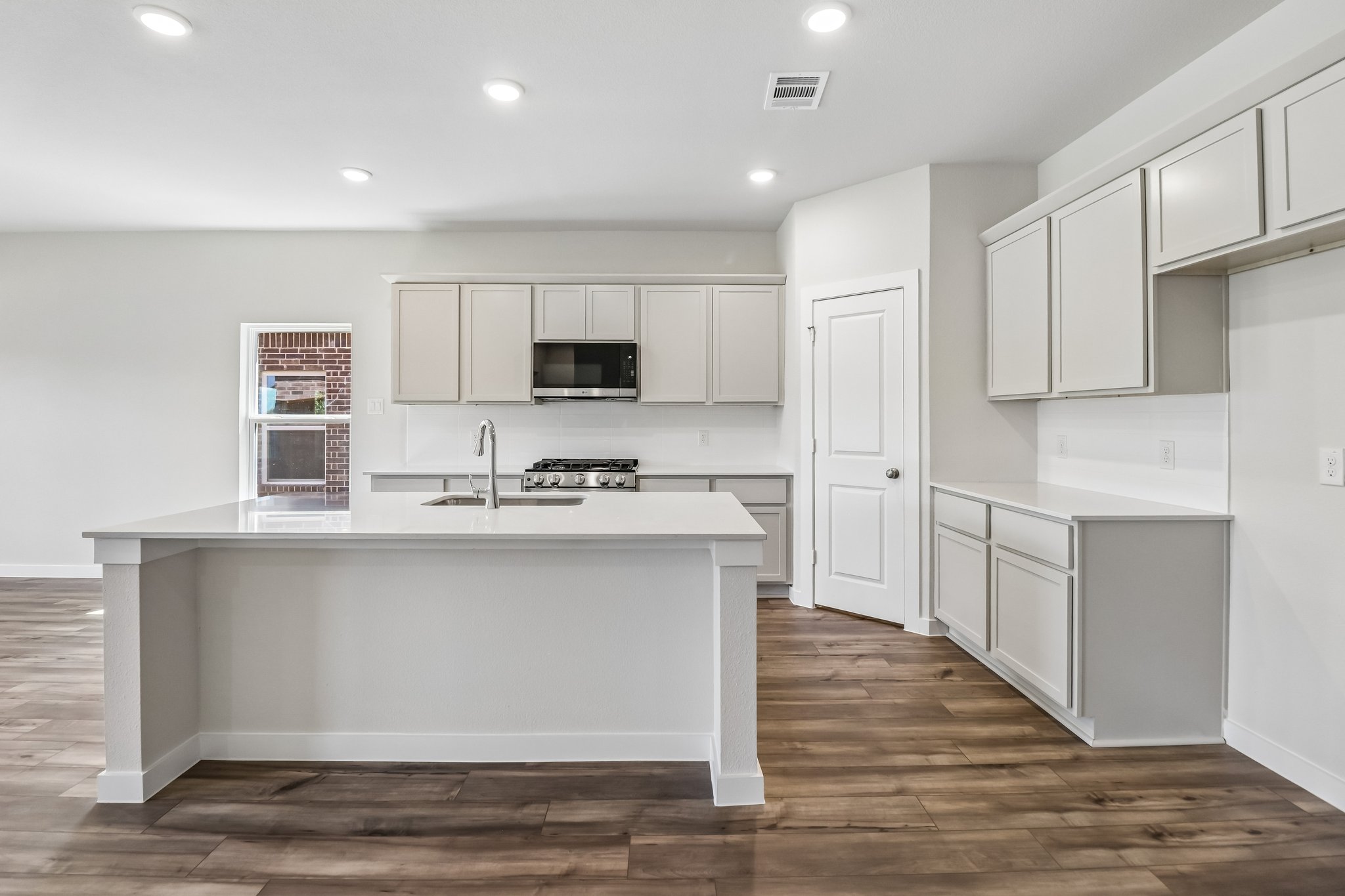 A kitchen with white cabinets.