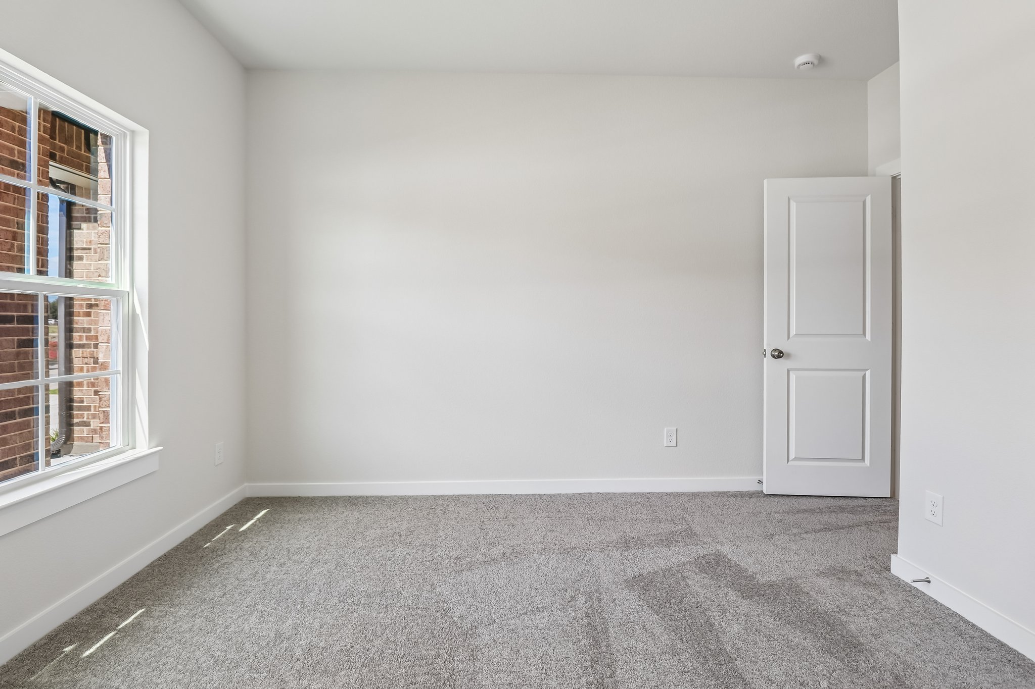 A room with a door and a window.