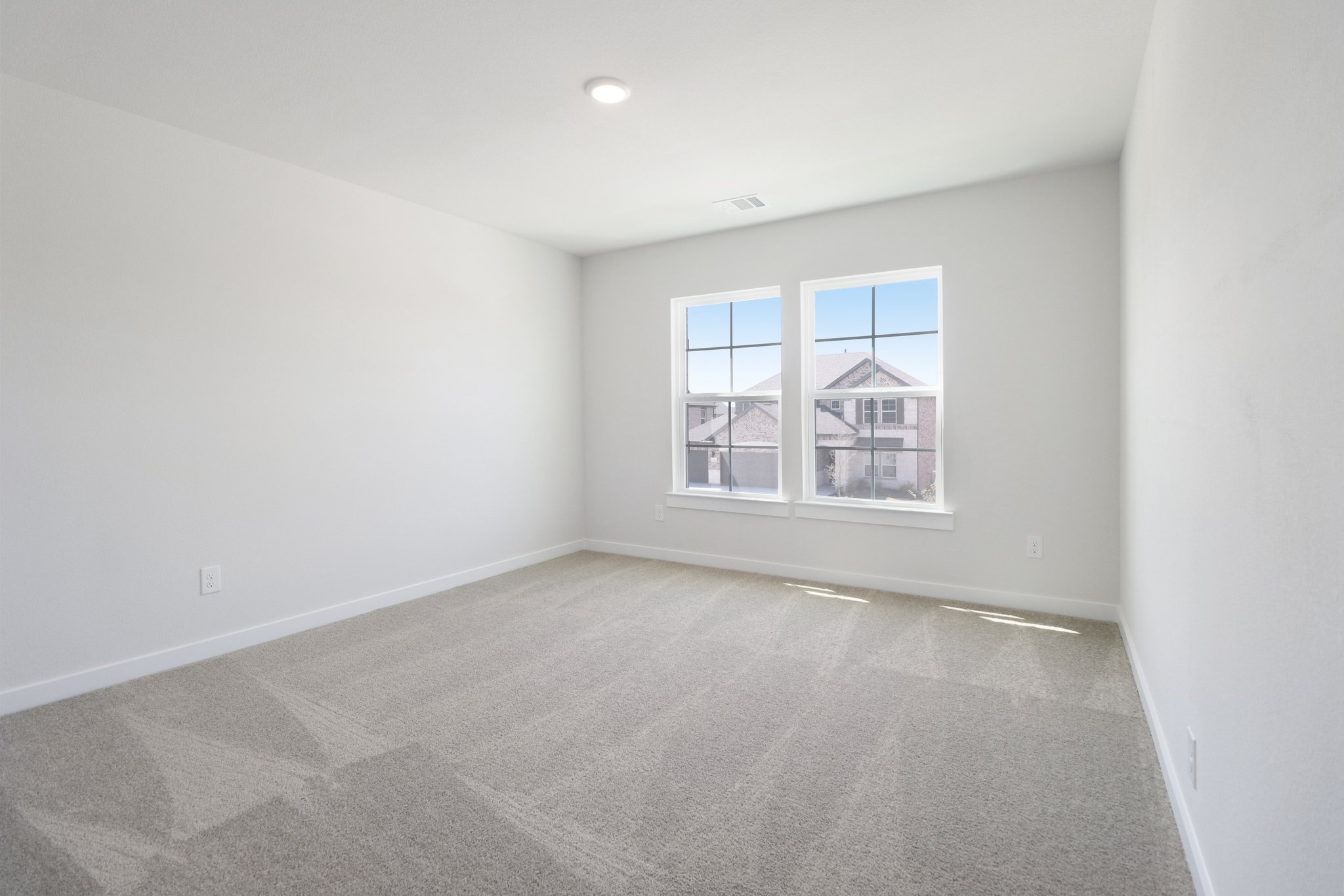 A room with a window and a carpet.