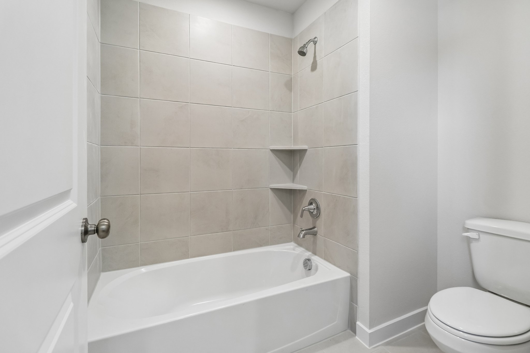 A bathroom with a tub toilet and sink.
