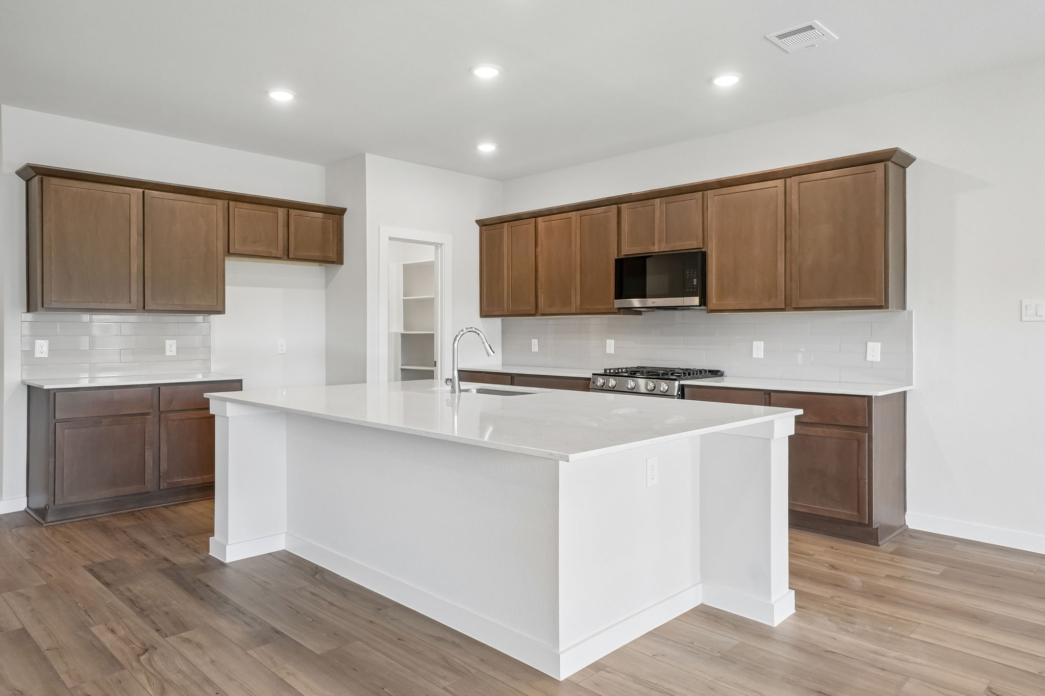 A kitchen with wooden cabinets.