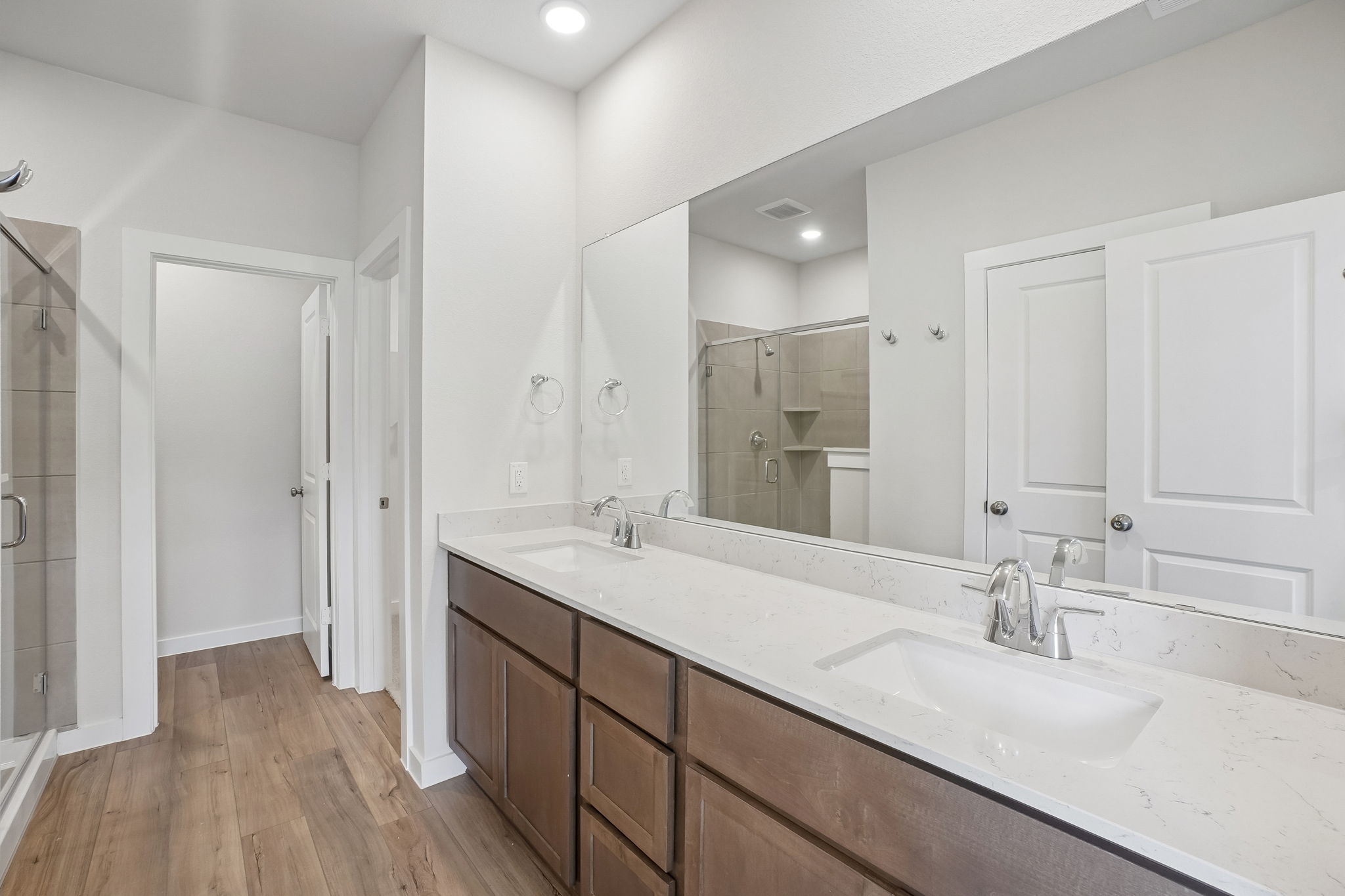 A bathroom with a large mirror.