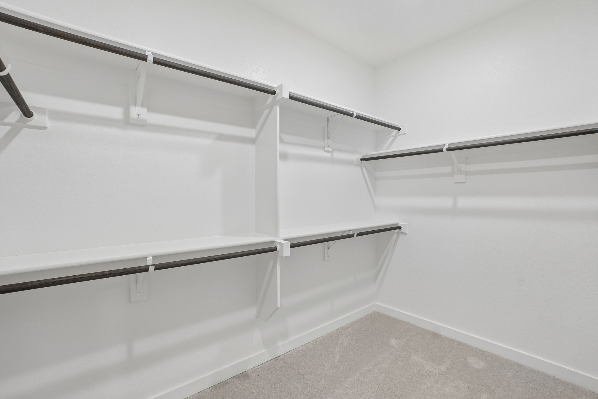 A white wall with a metal railing.