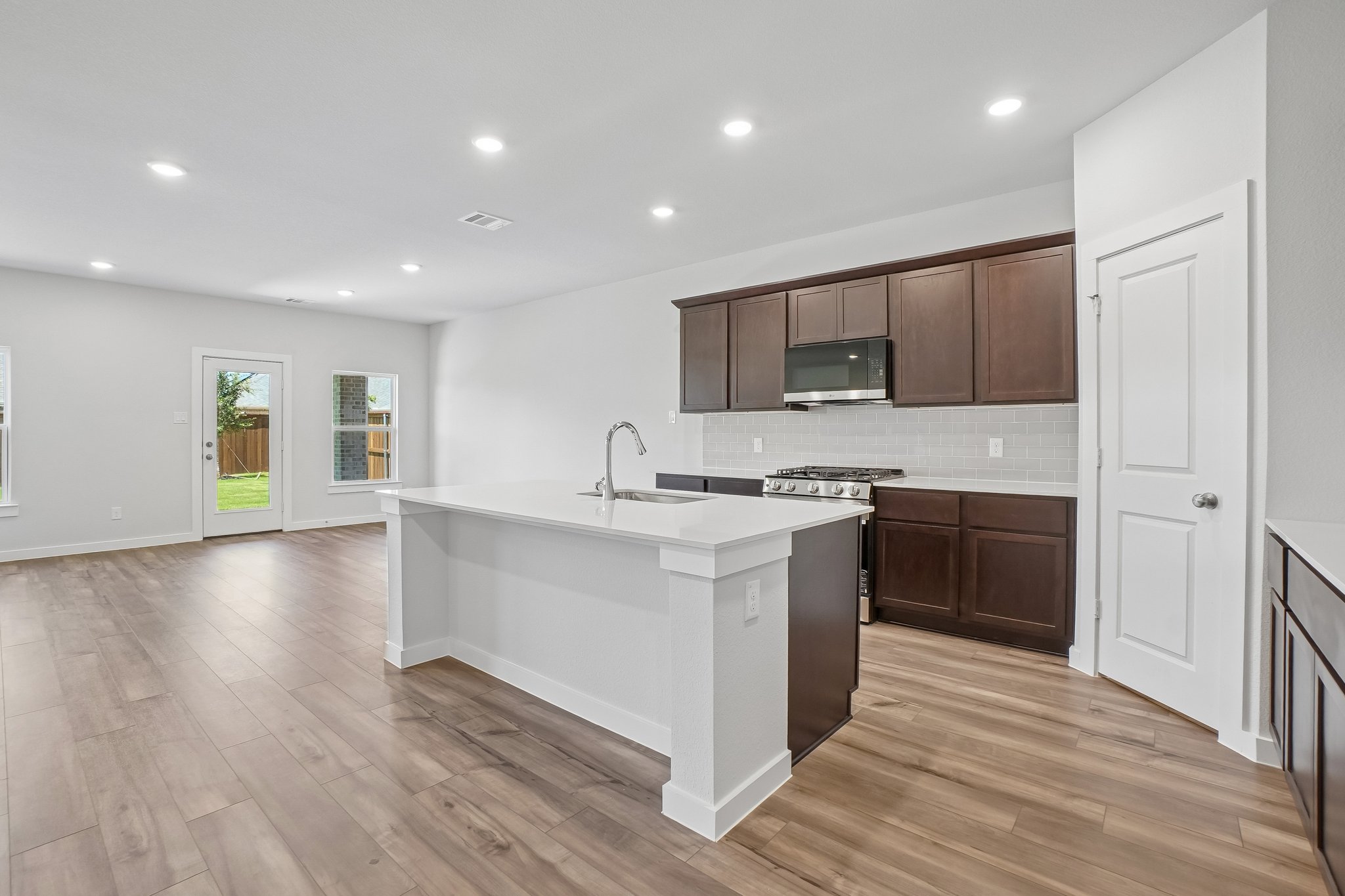 A kitchen with wooden cabinets.