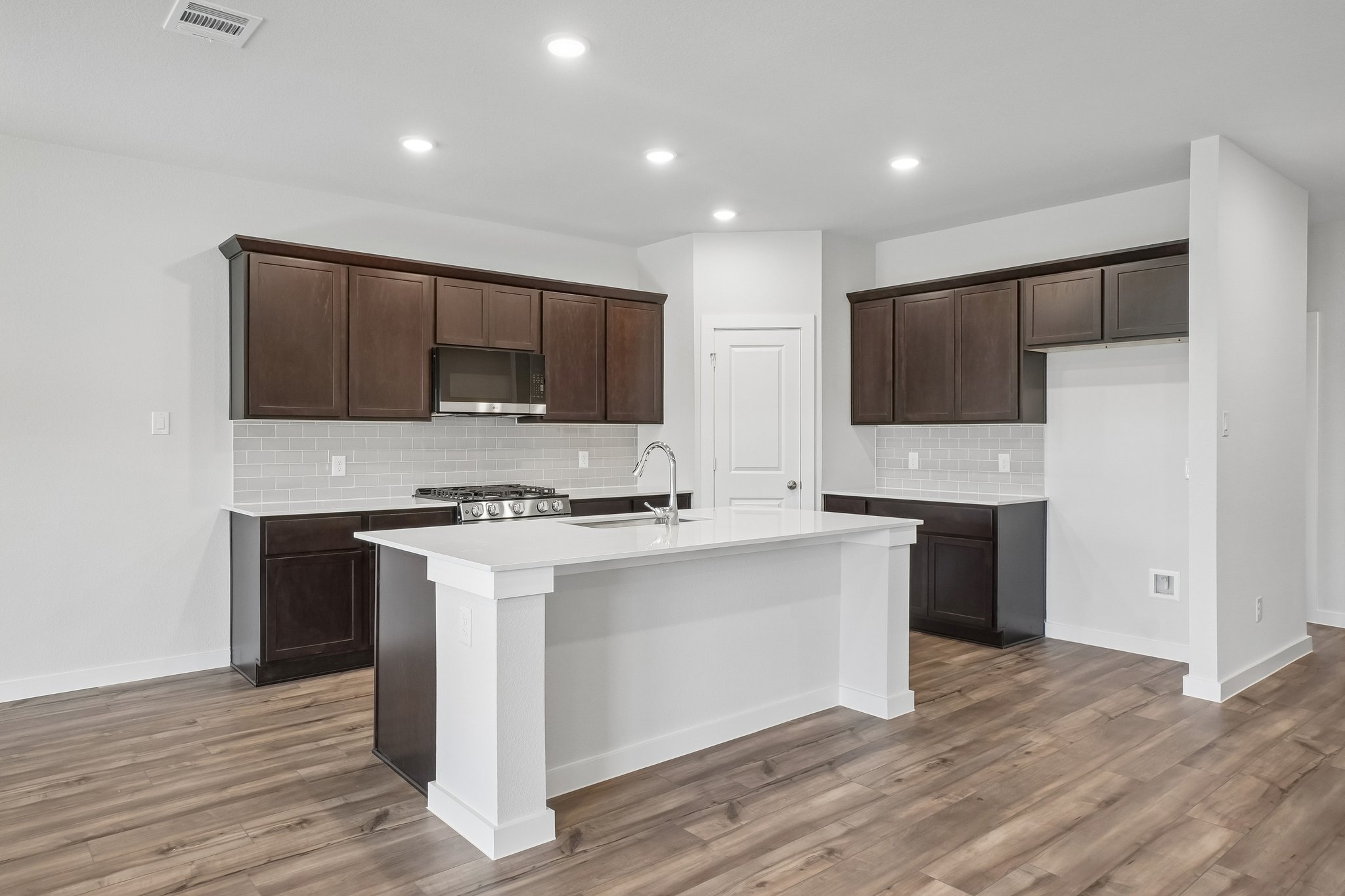 A kitchen with wooden cabinets.