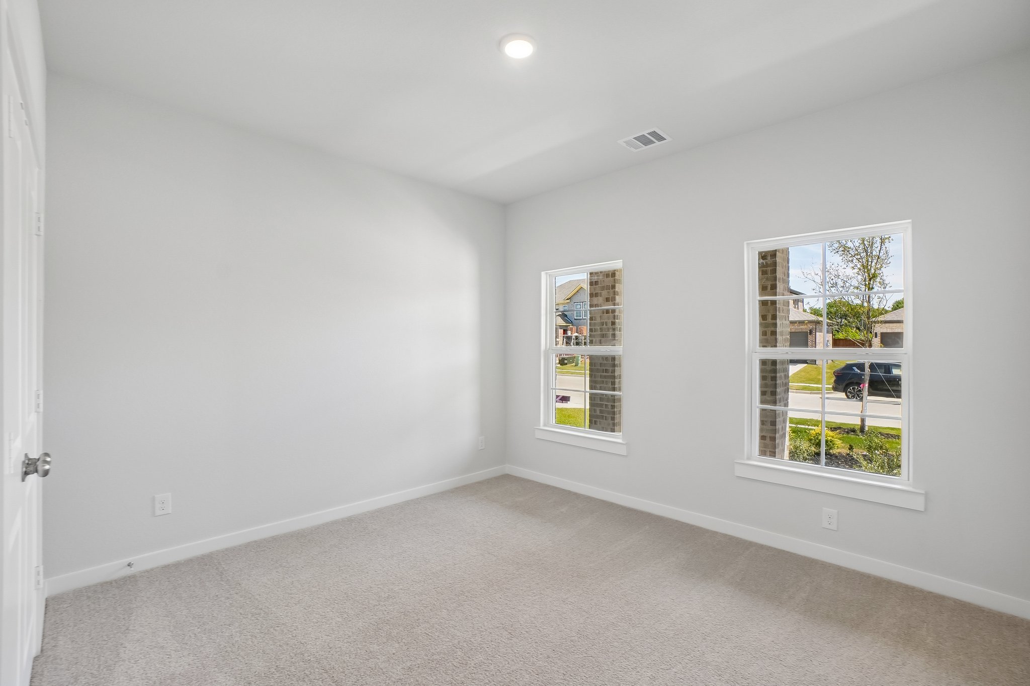 A room with a window and a carpet.