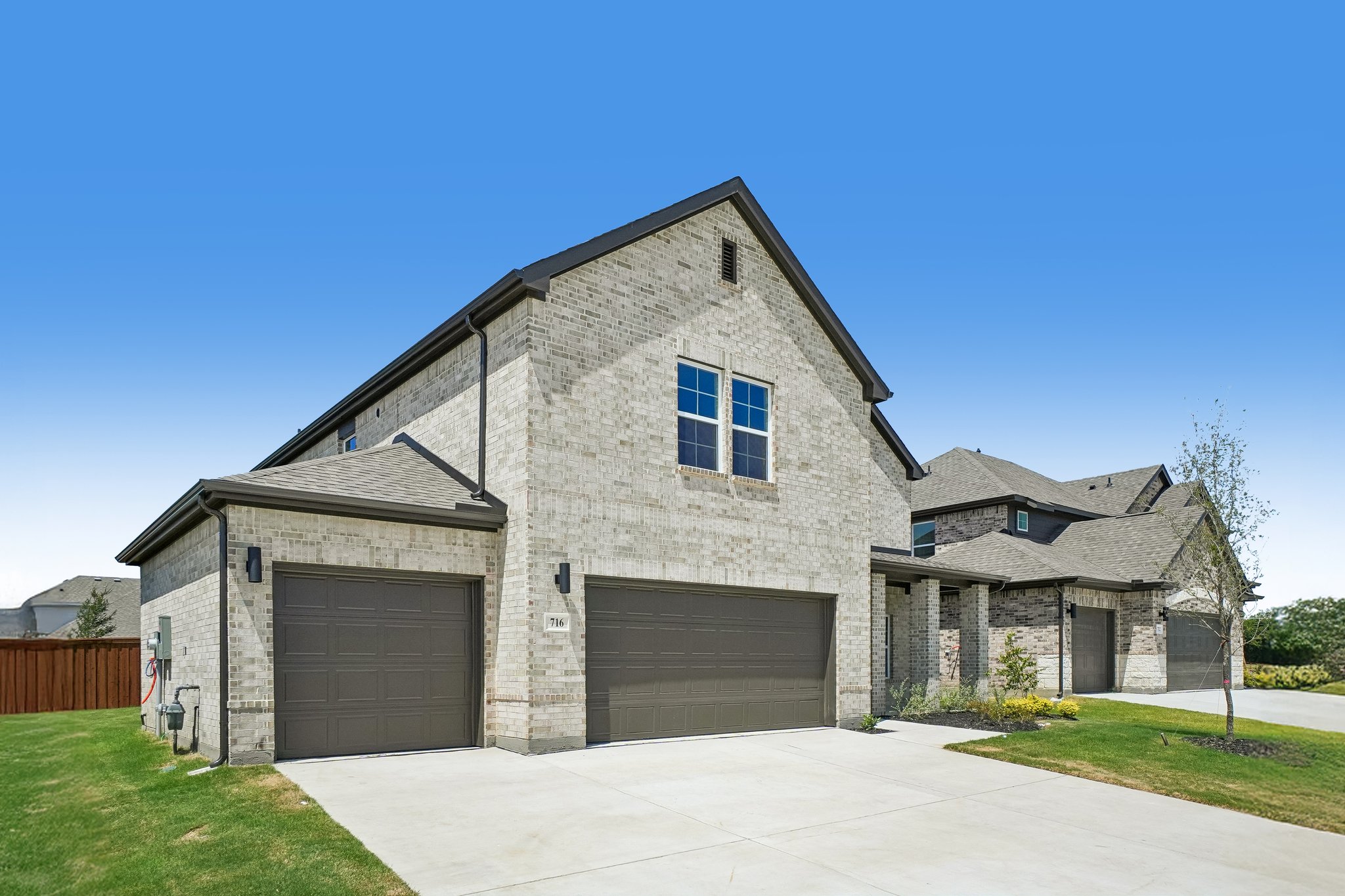A house with garages and a driveway.