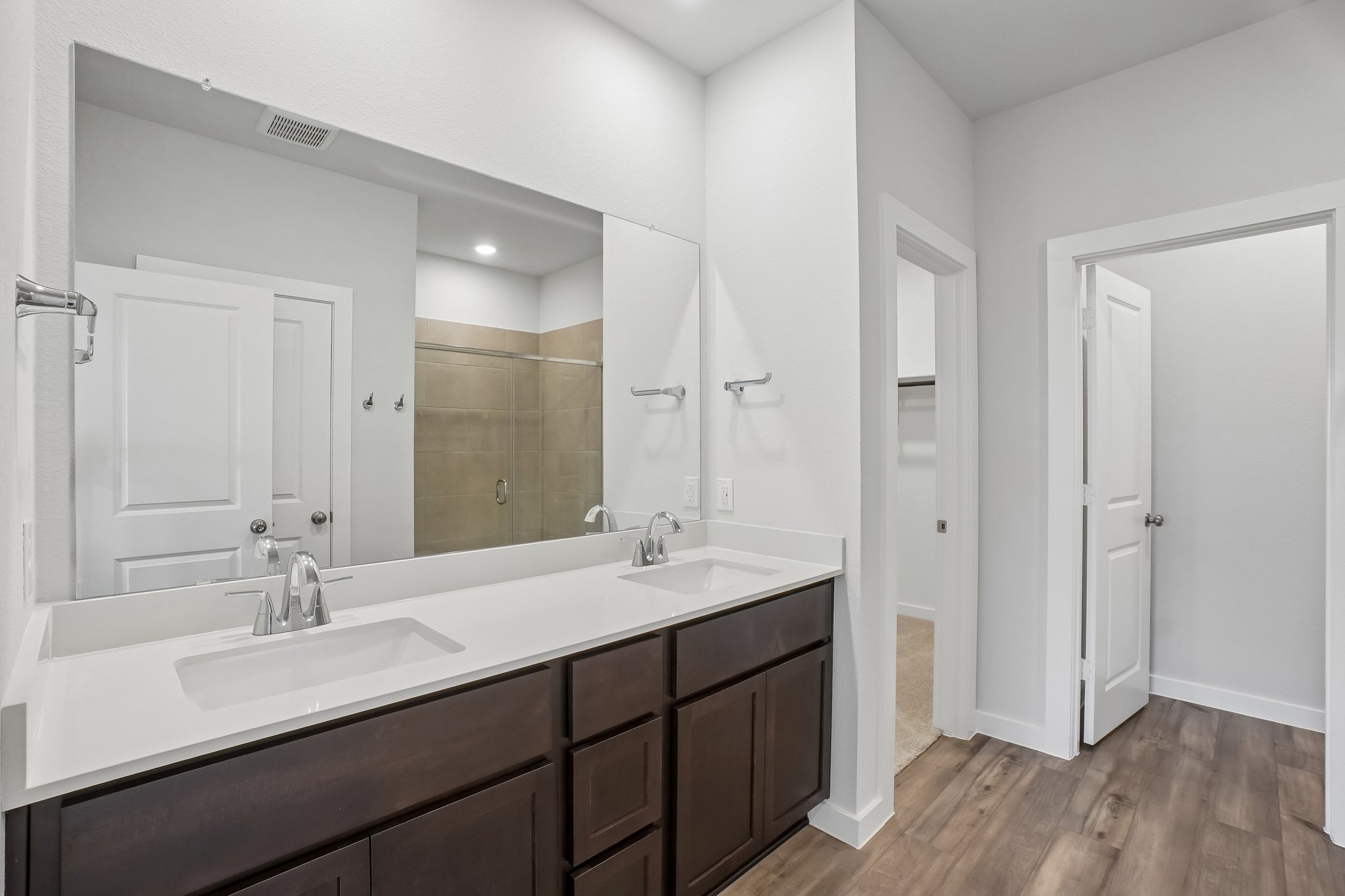 A bathroom with a large mirror.