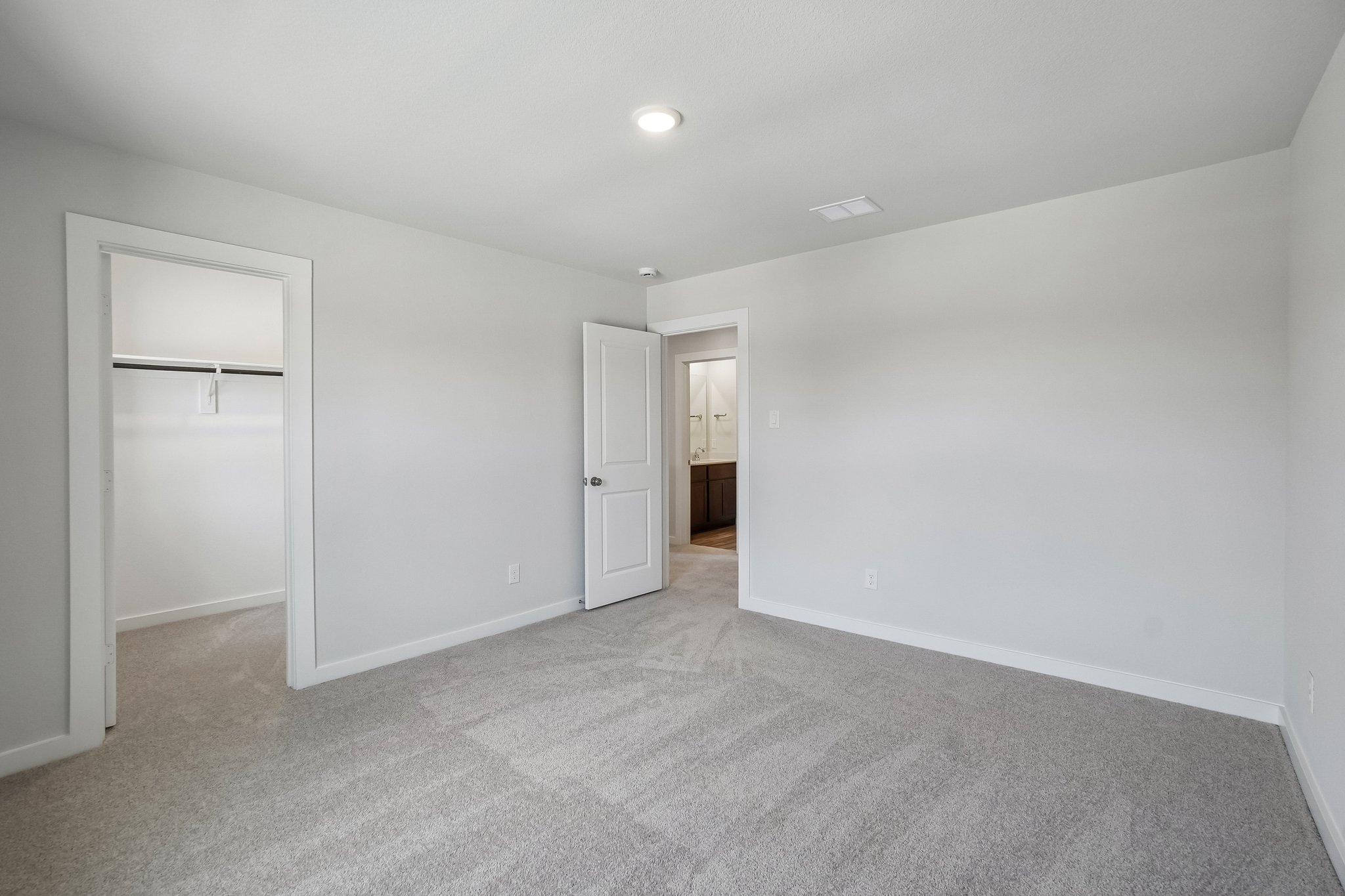 A hallway with white walls.