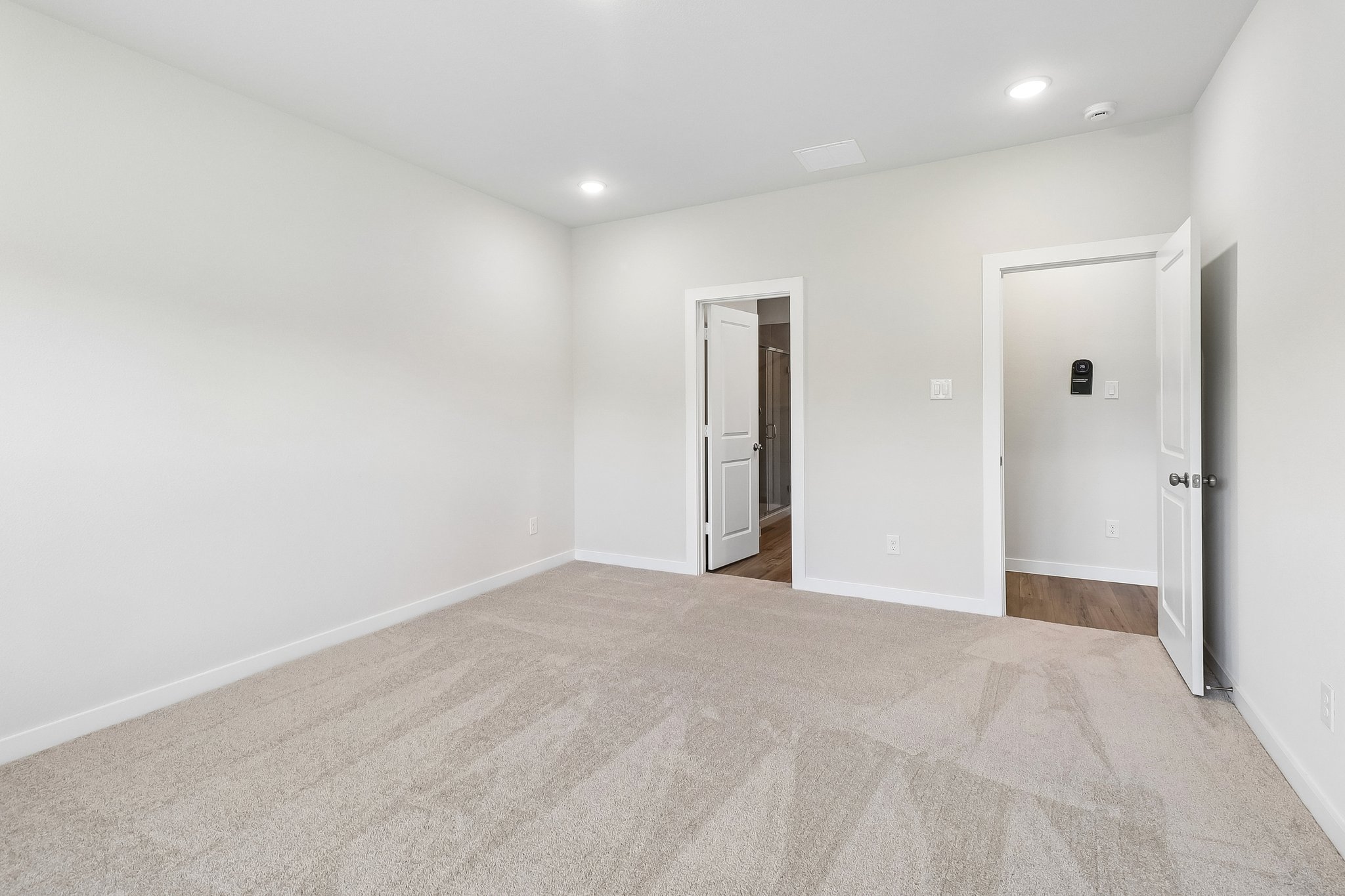 A hallway with white walls.
