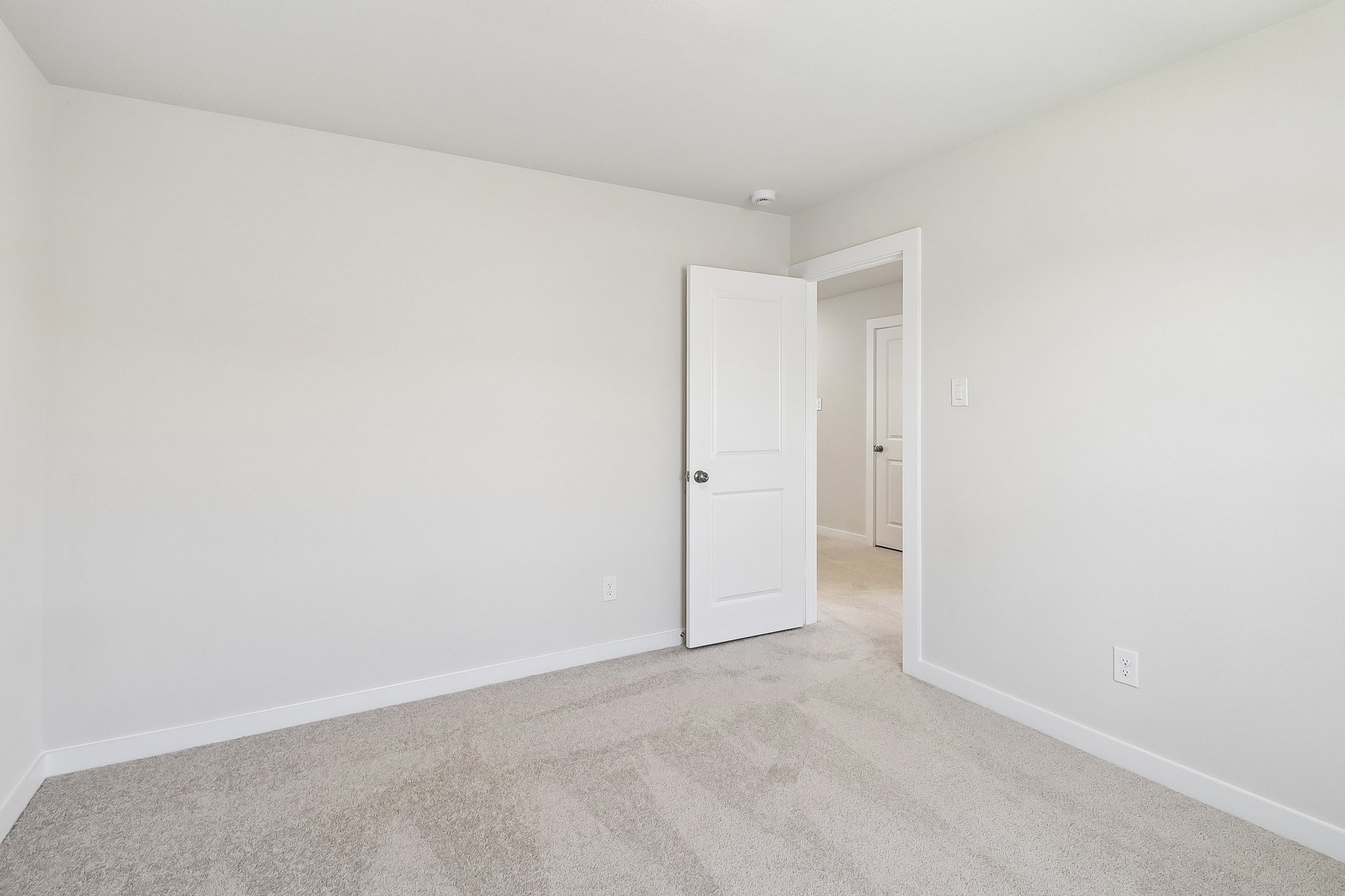 A hallway with white doors.