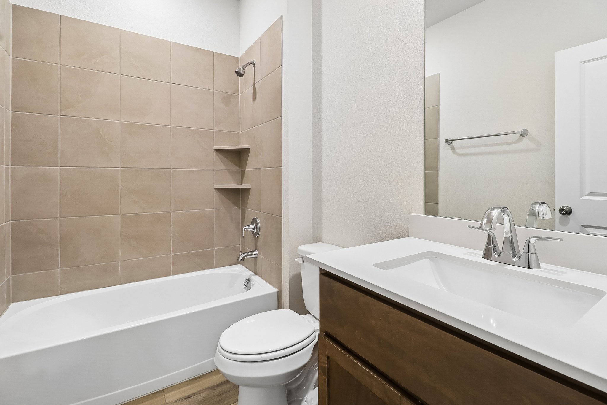 A bathroom with a tub sink and toilet.