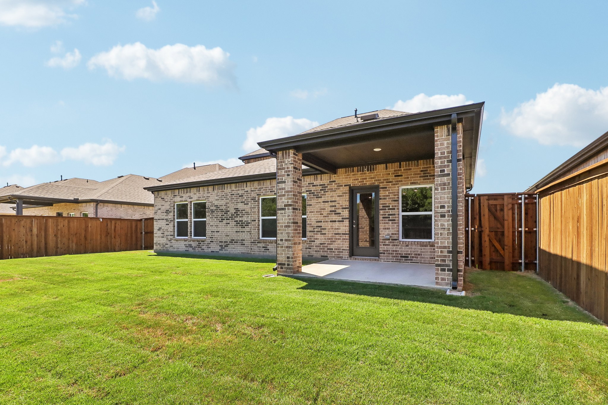 A house with a fence and grass.