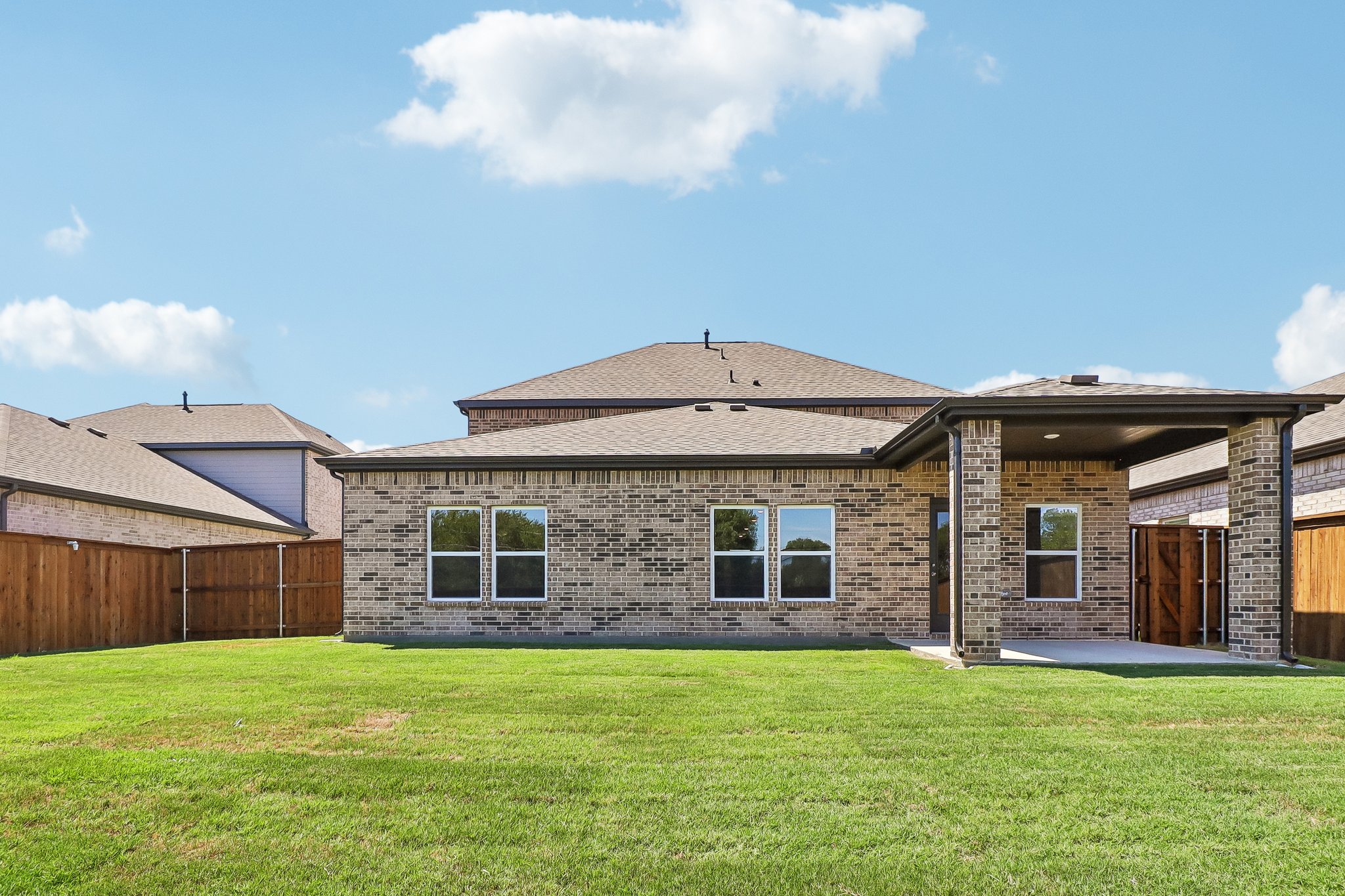 A house with a grass yard.
