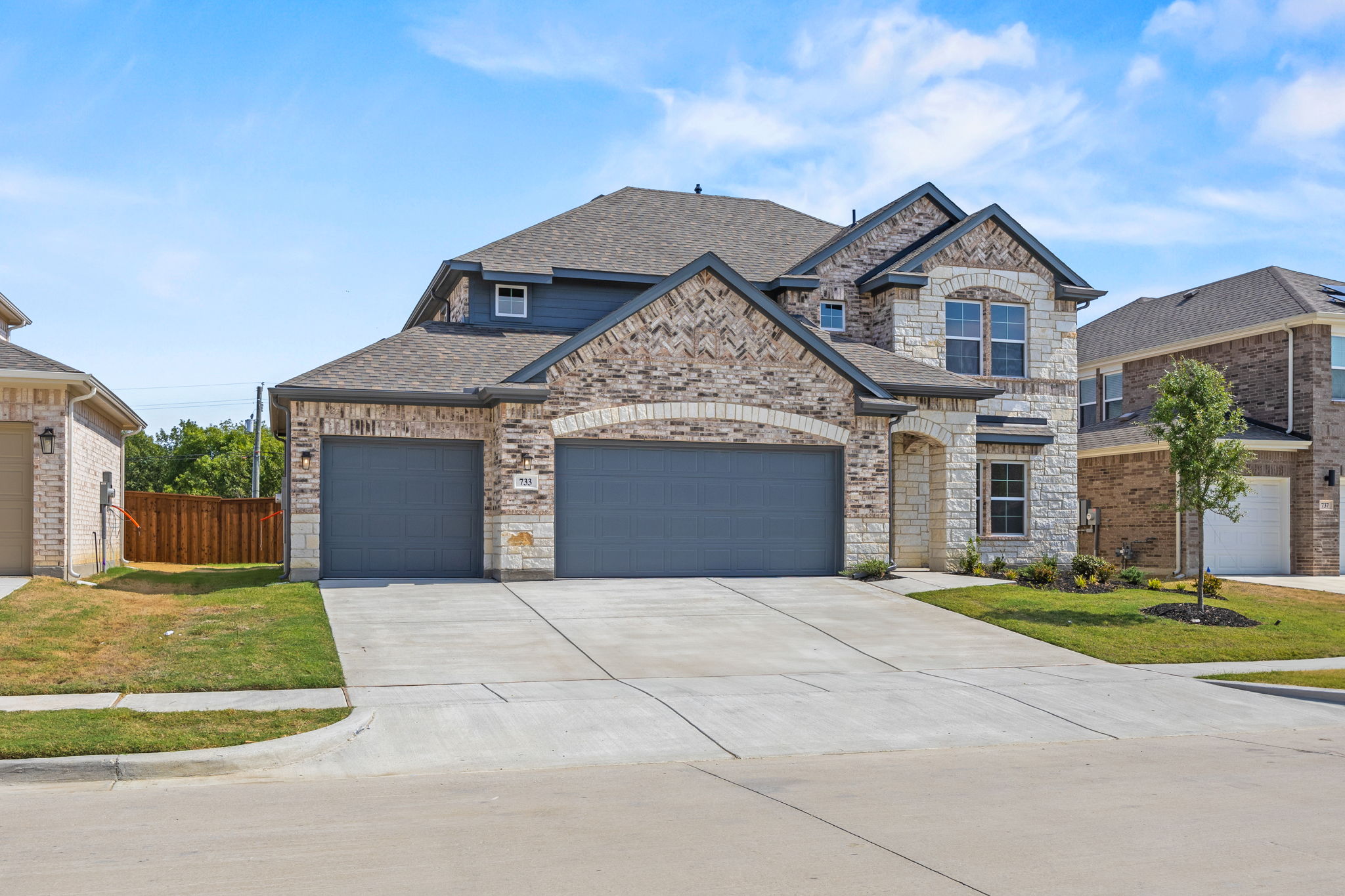 A house with garages and a driveway.