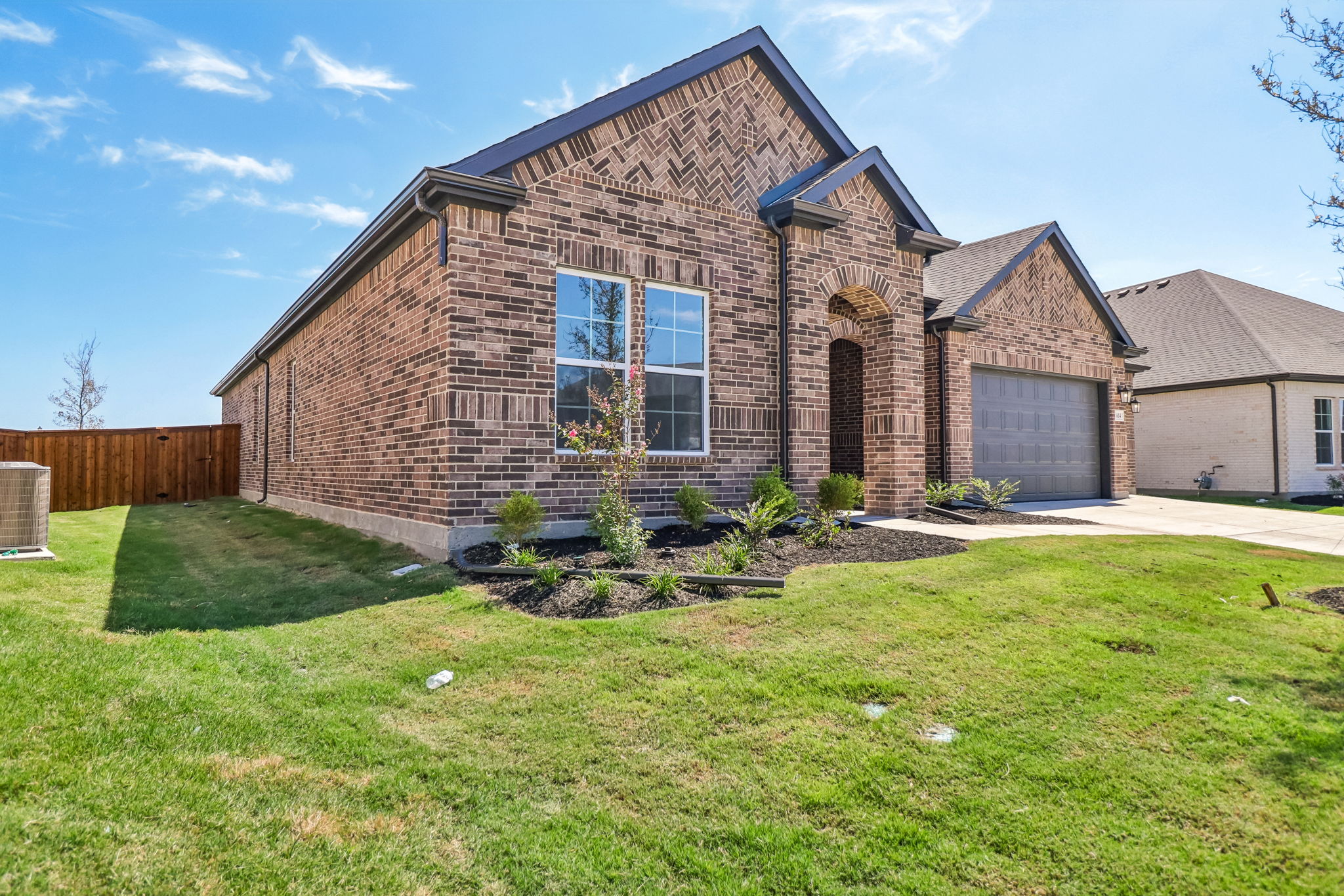 A house with a yard and a fence.