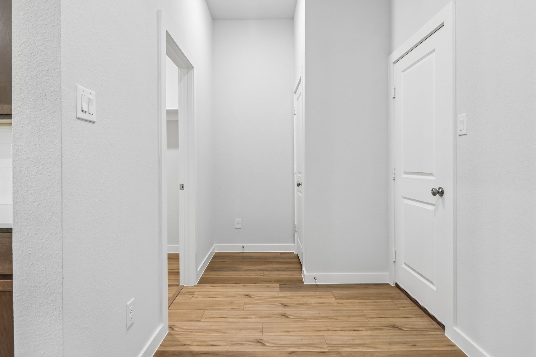 A hallway with white doors.