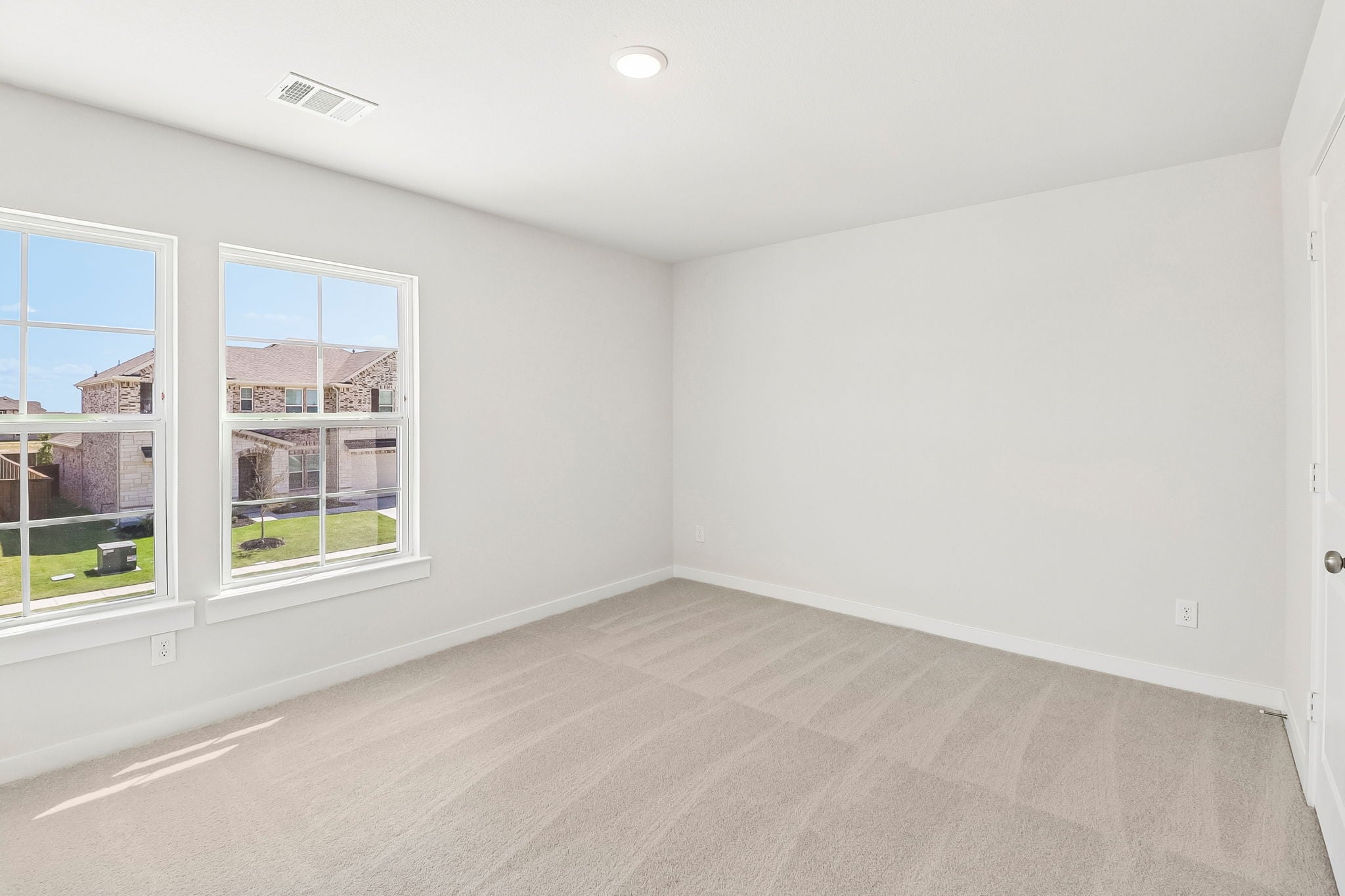 A room with a window and a carpet.