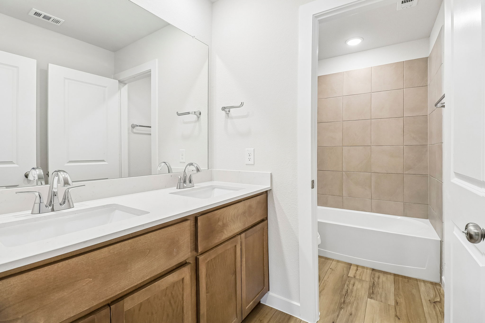 A bathroom with a tub sink and a bathtub.