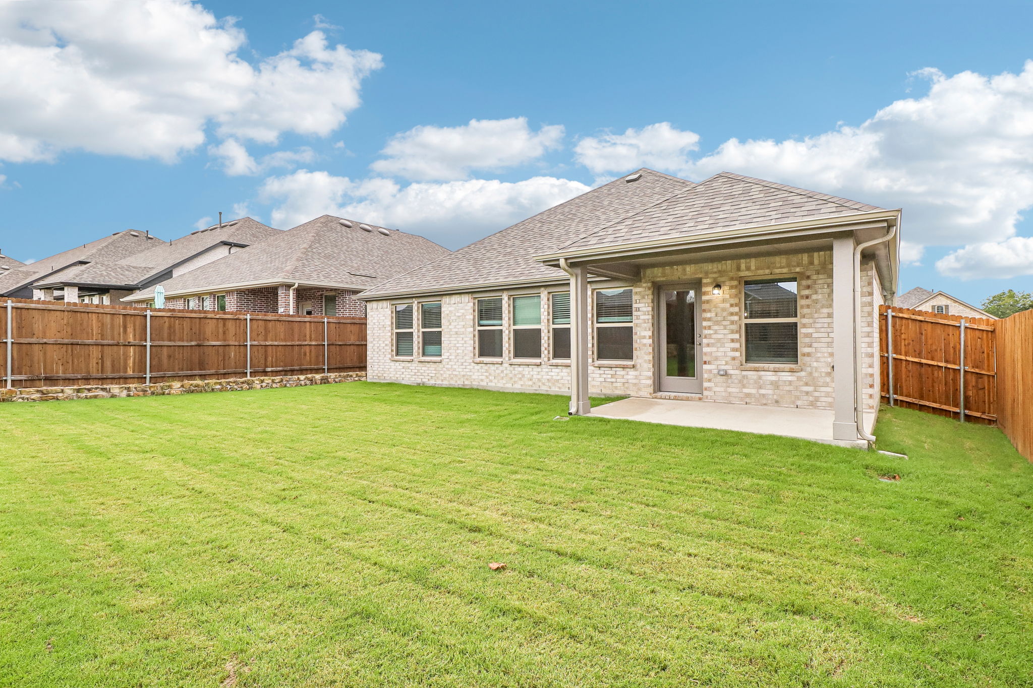 A house with a fence and grass.