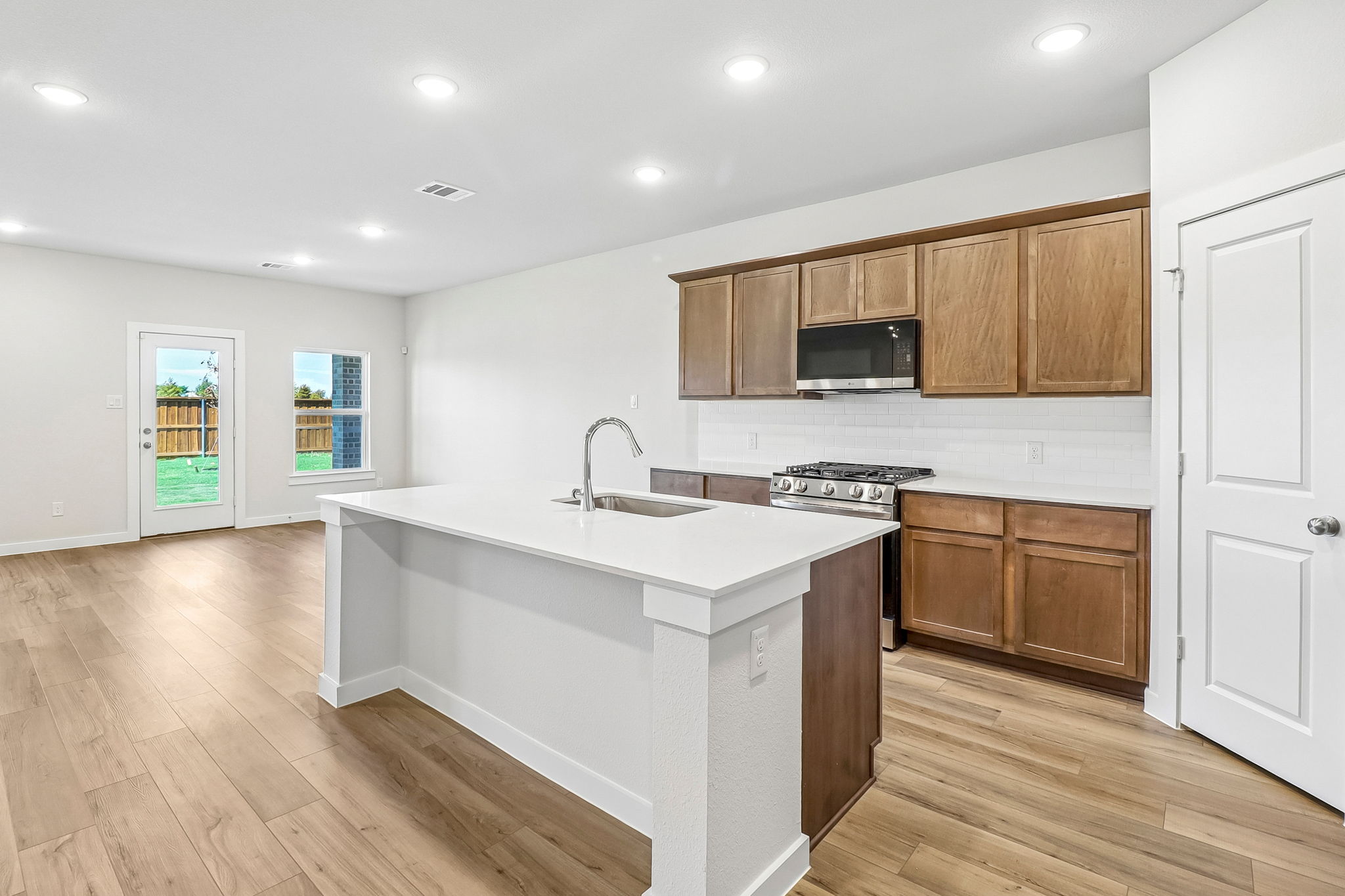 A kitchen with wooden cabinets.