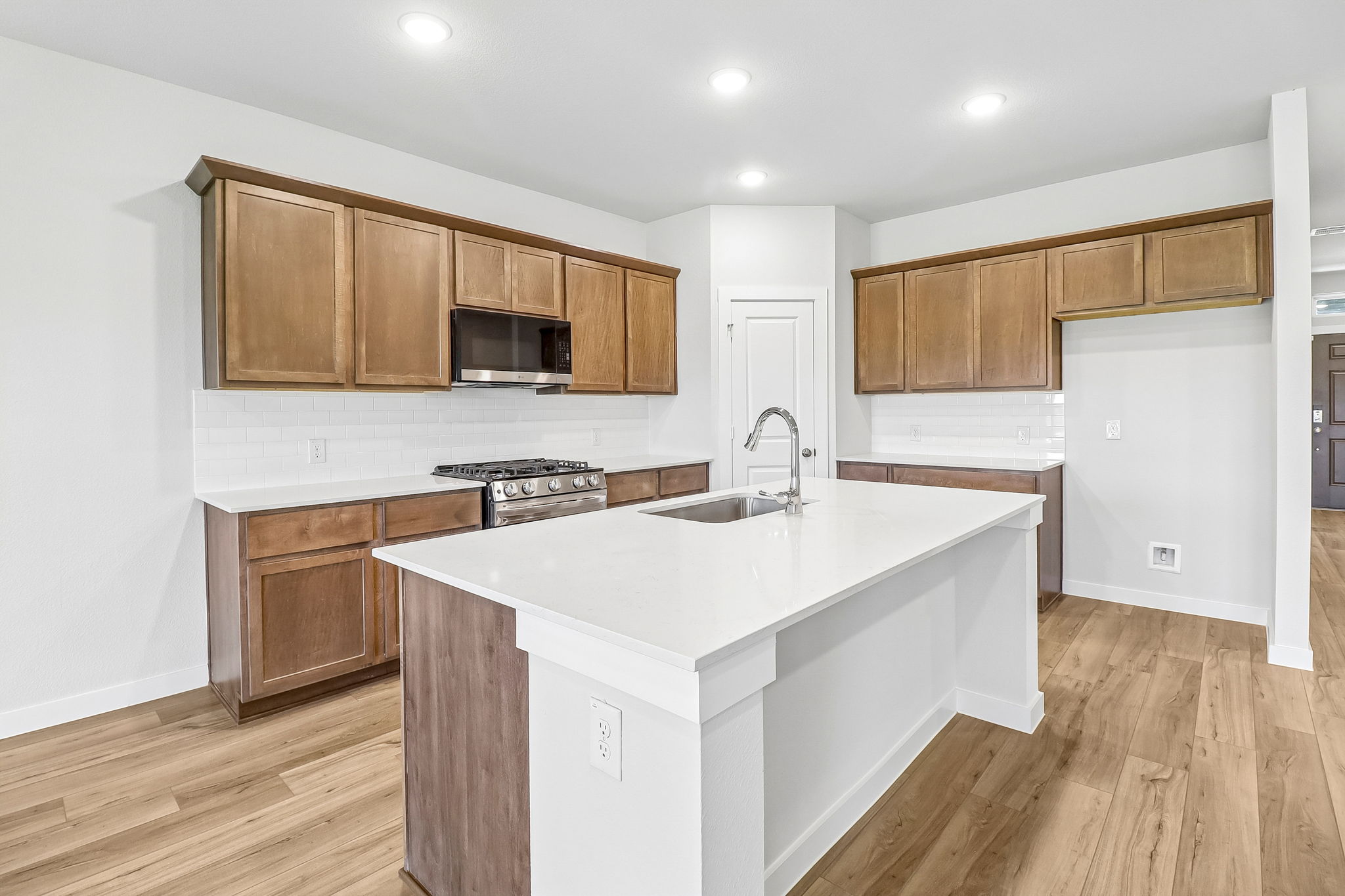 A kitchen with wooden cabinets.