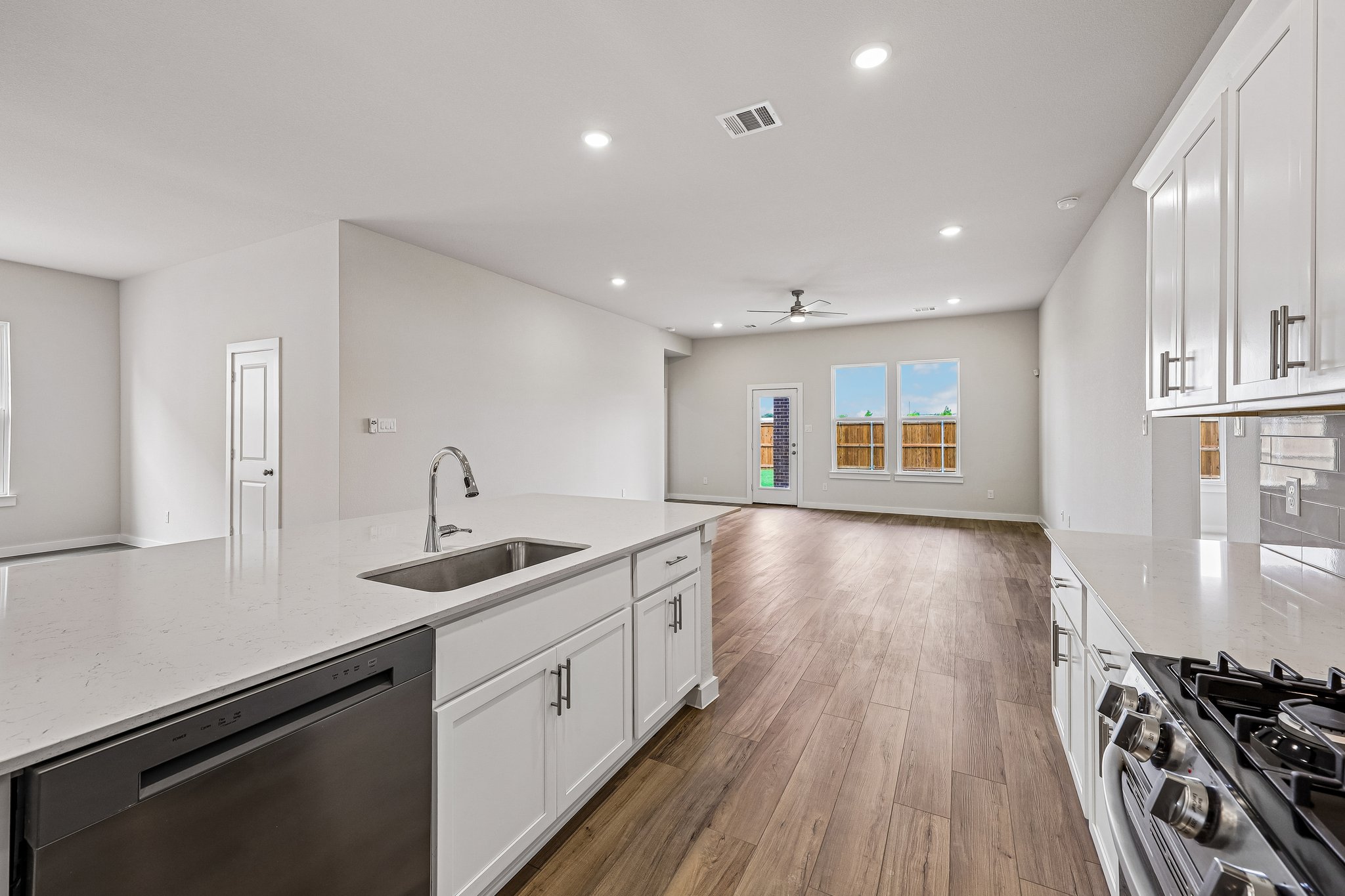A kitchen with white cabinets.