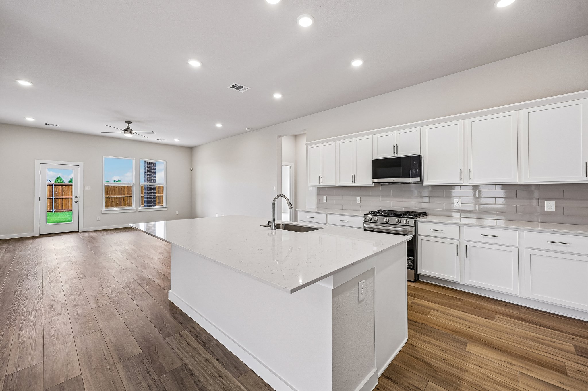 A kitchen with white cabinets.