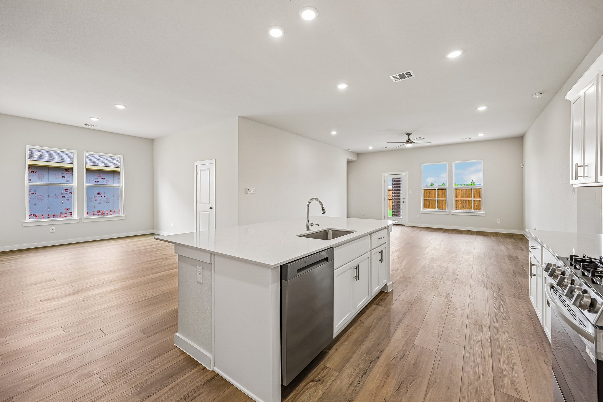 A kitchen with white cabinets.