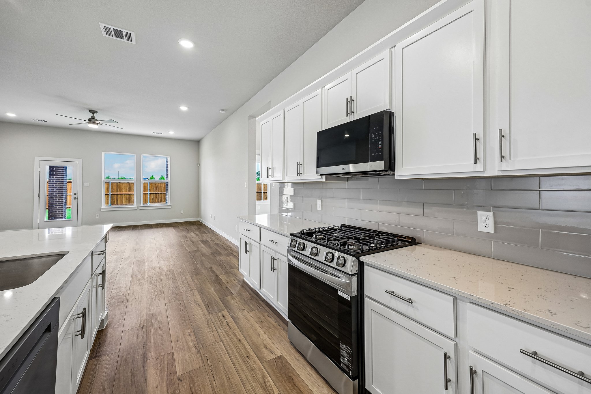 A kitchen with white cabinets.