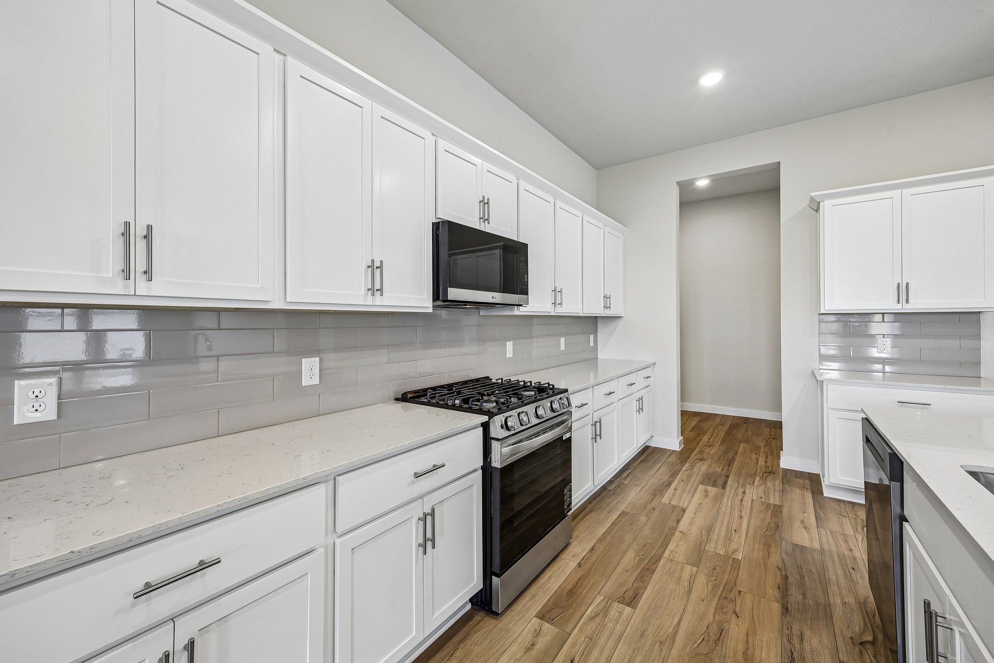 A kitchen with white cabinets.