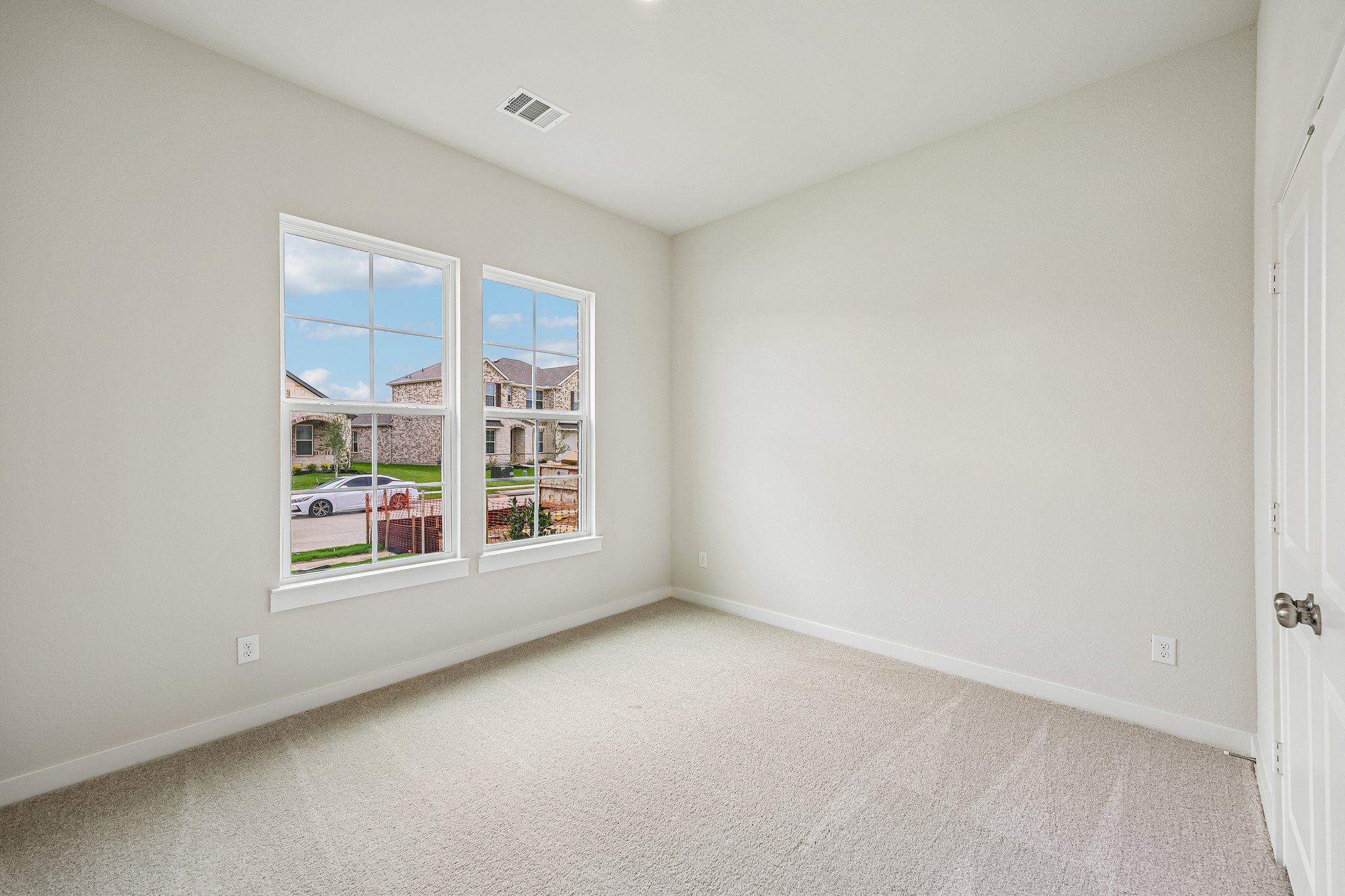A room with a window and a door.