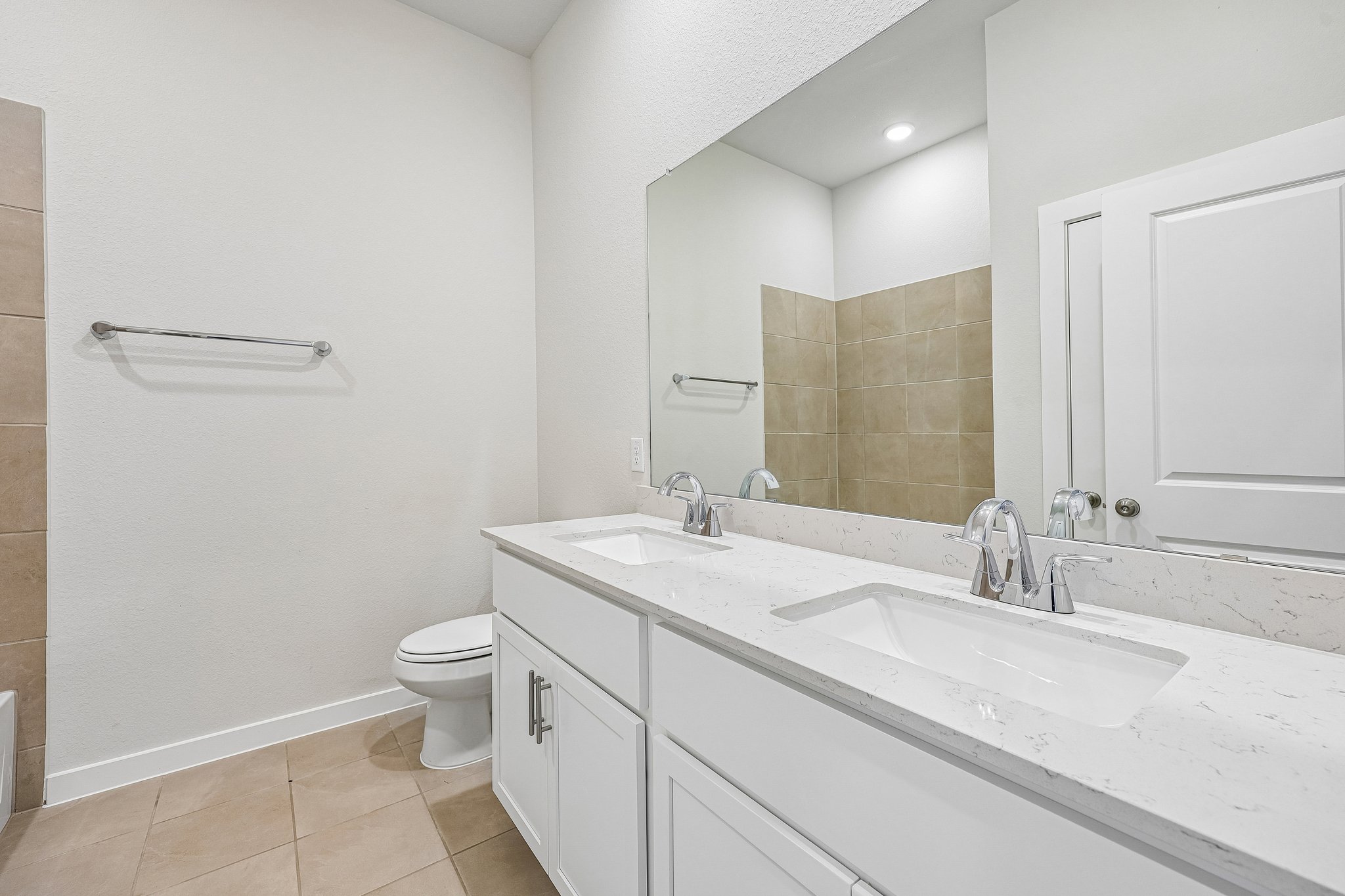 A bathroom with a large mirror.