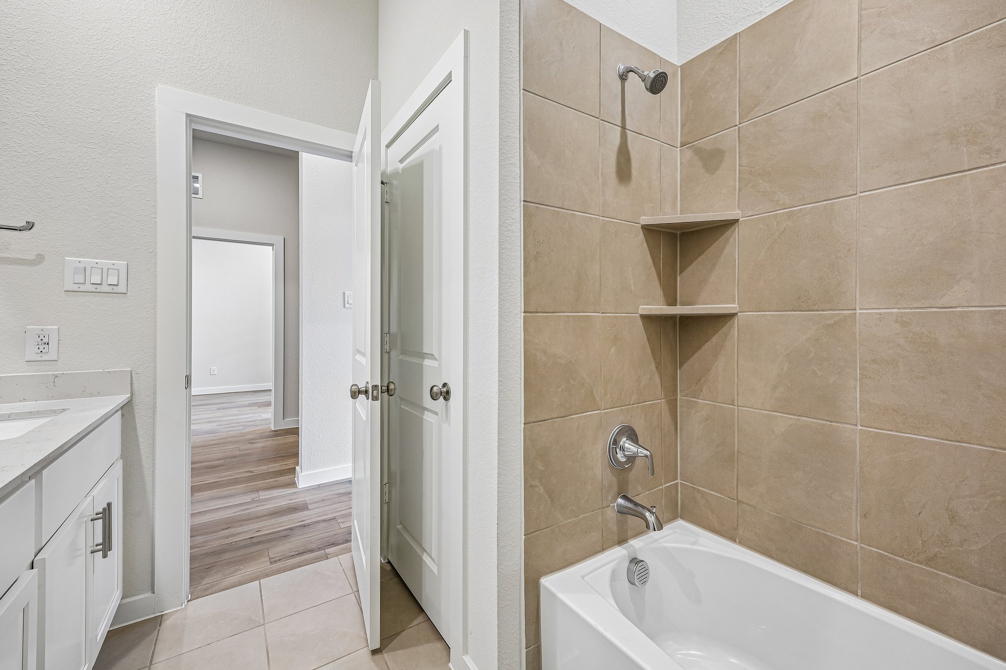 A bathroom with a tub and sink.