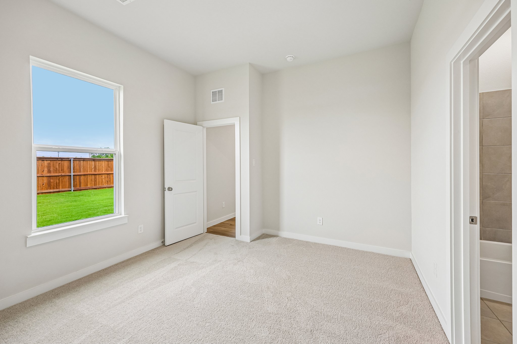 A room with a window and a door.