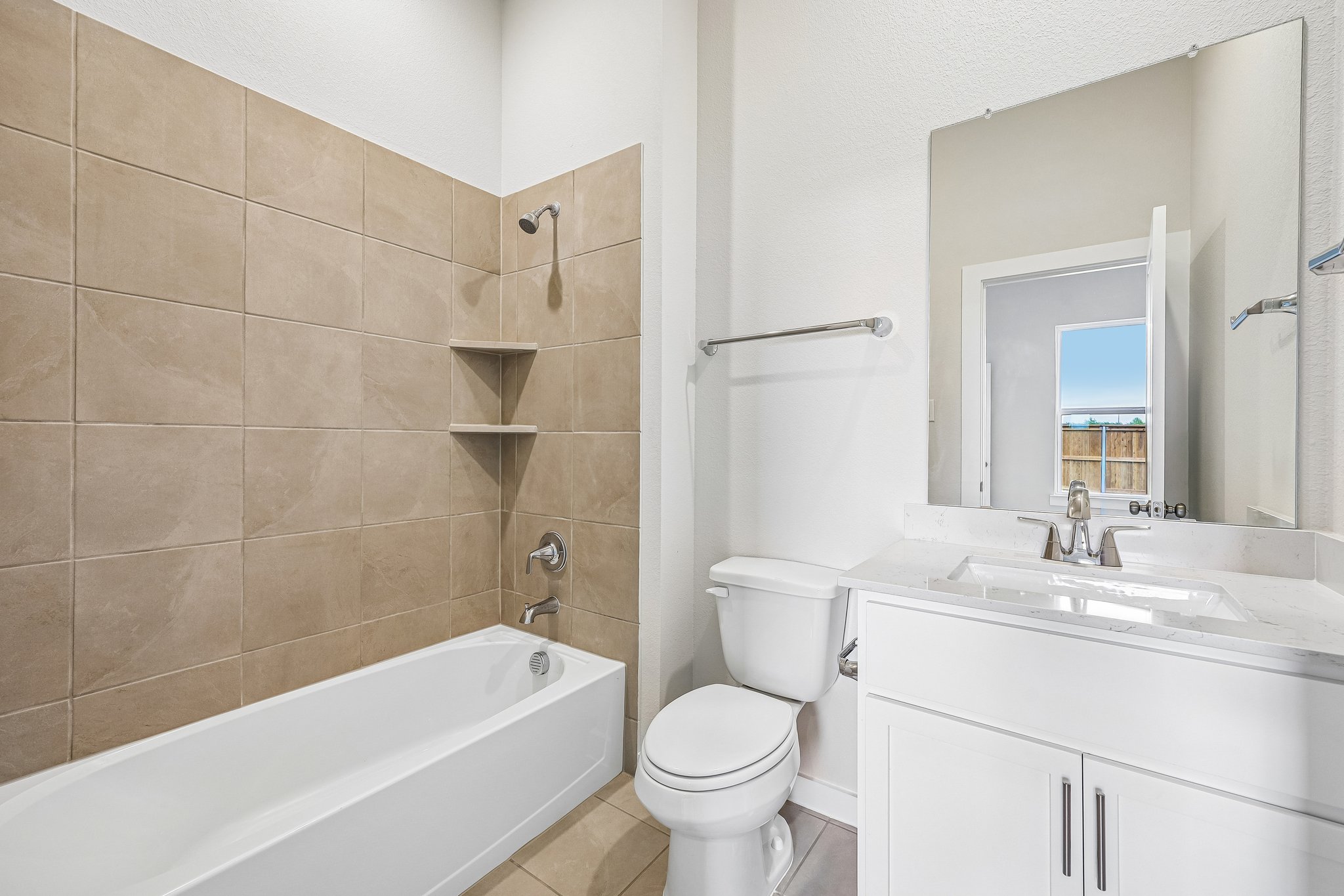 A bathroom with a tub toilet and sink.