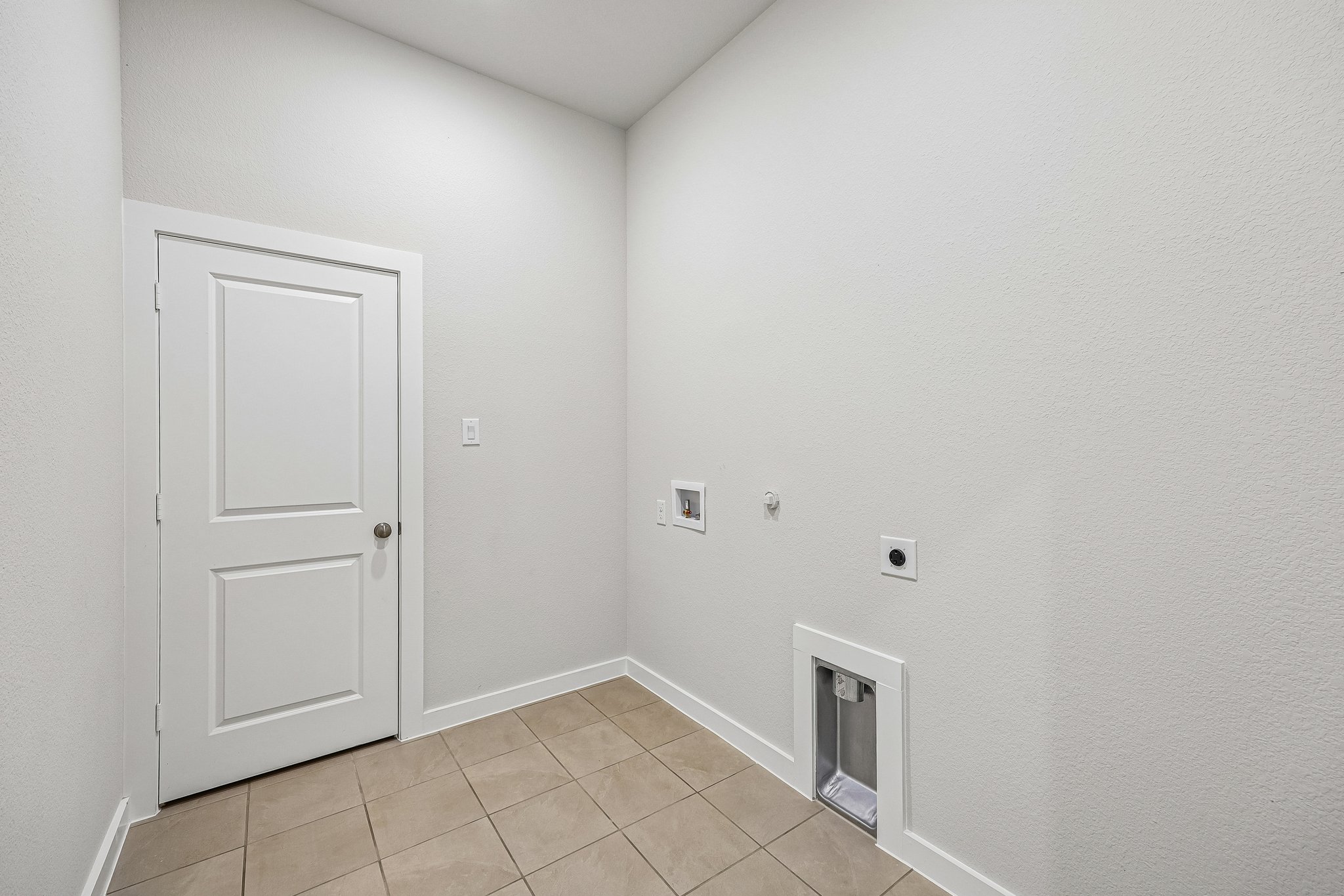 A white room with a white door.