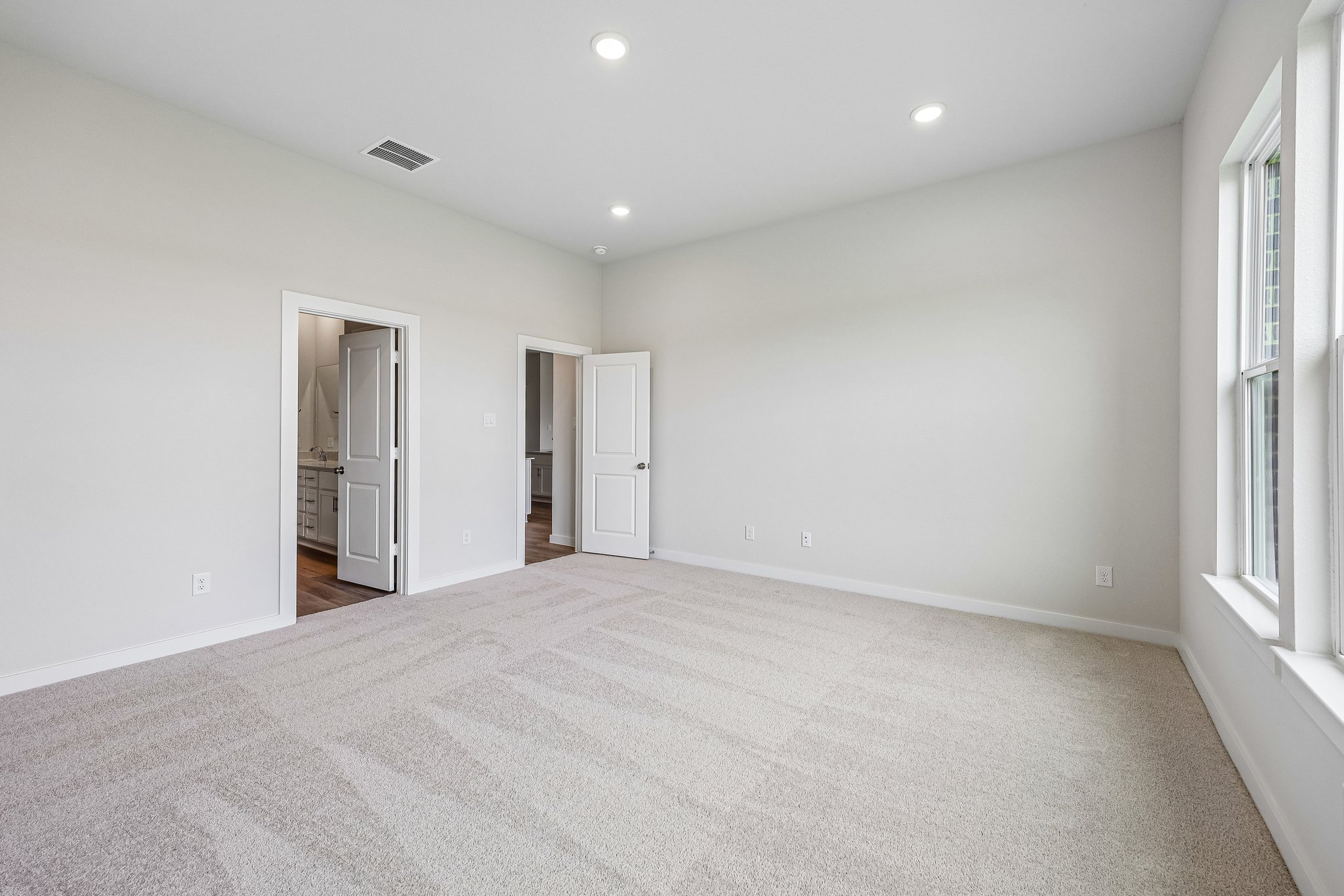 A long hallway with white walls.