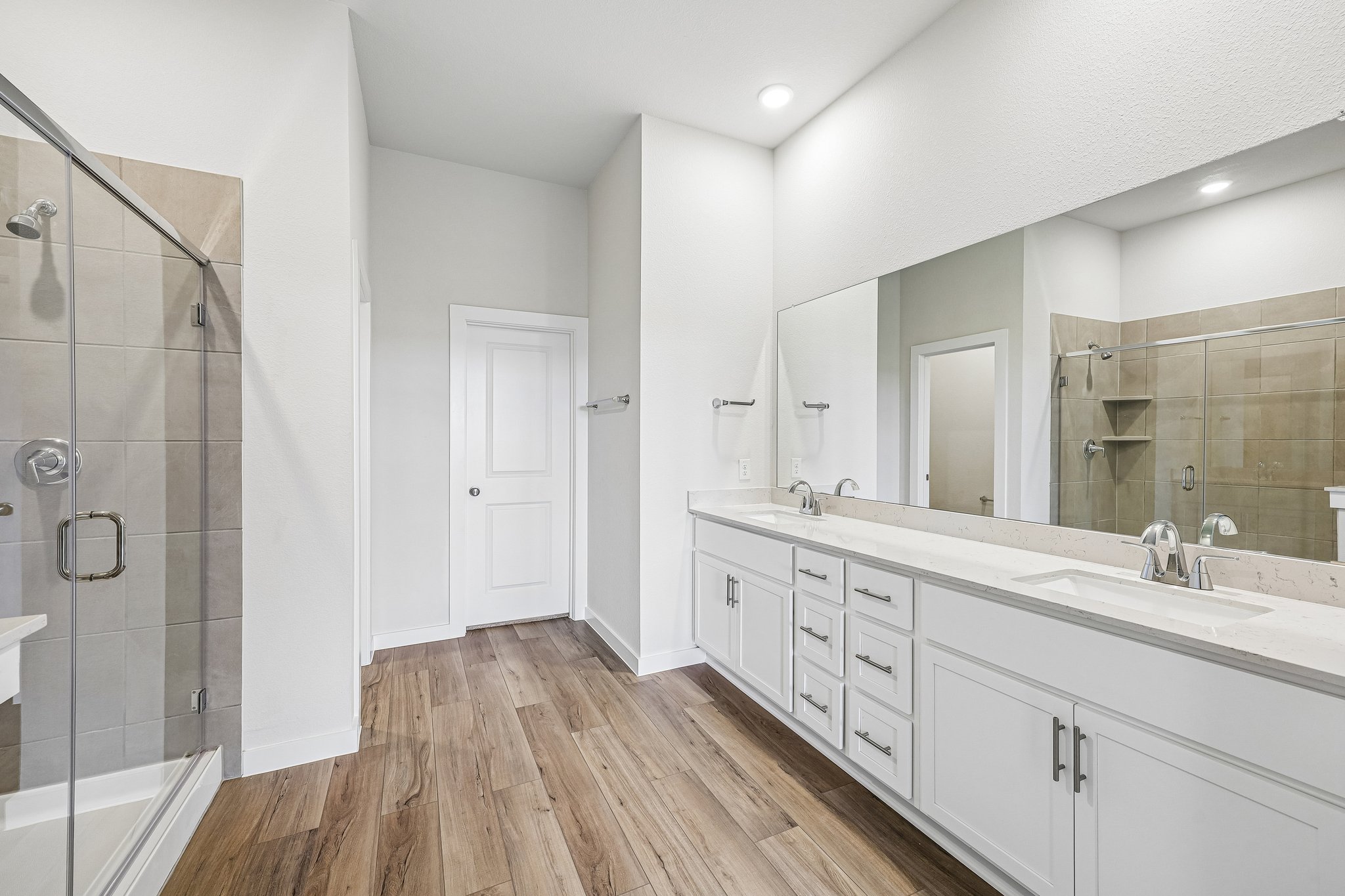 A bathroom with a large mirror.