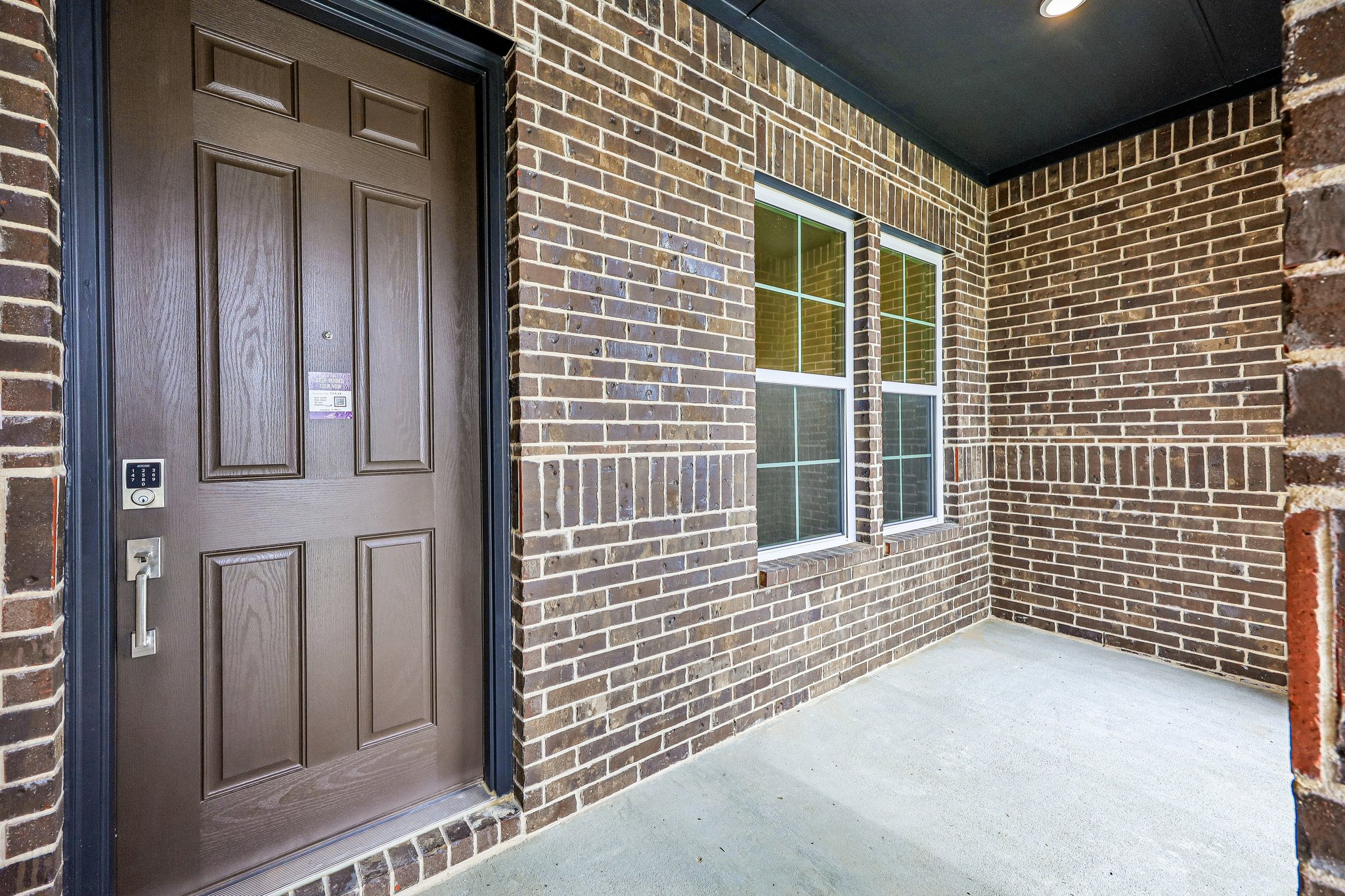A brick building with a door and windows.