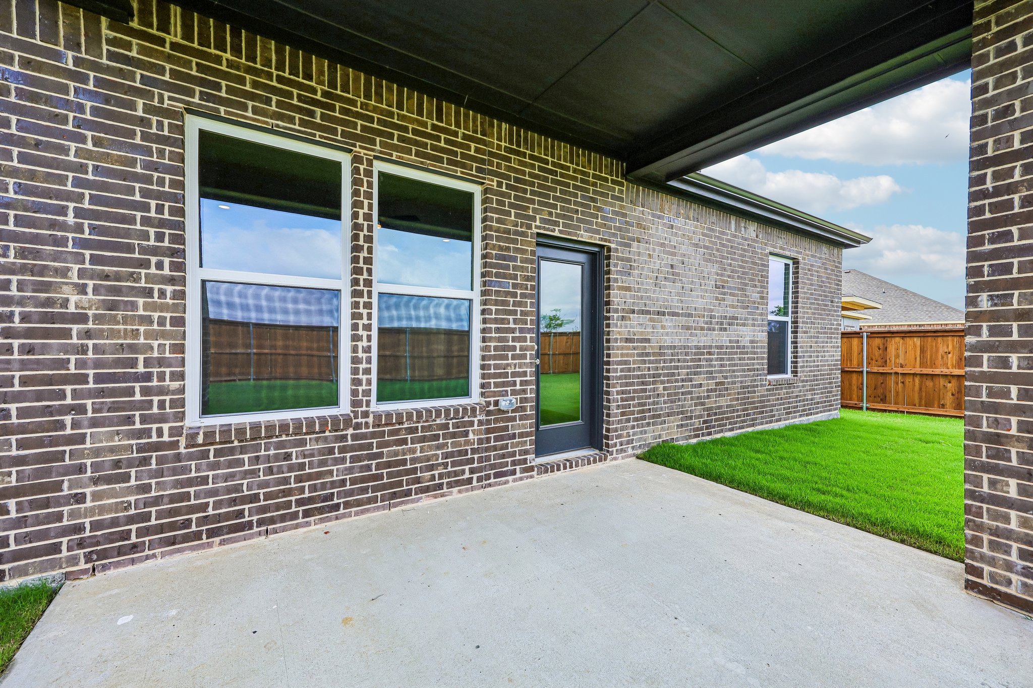A brick building with a green lawn.