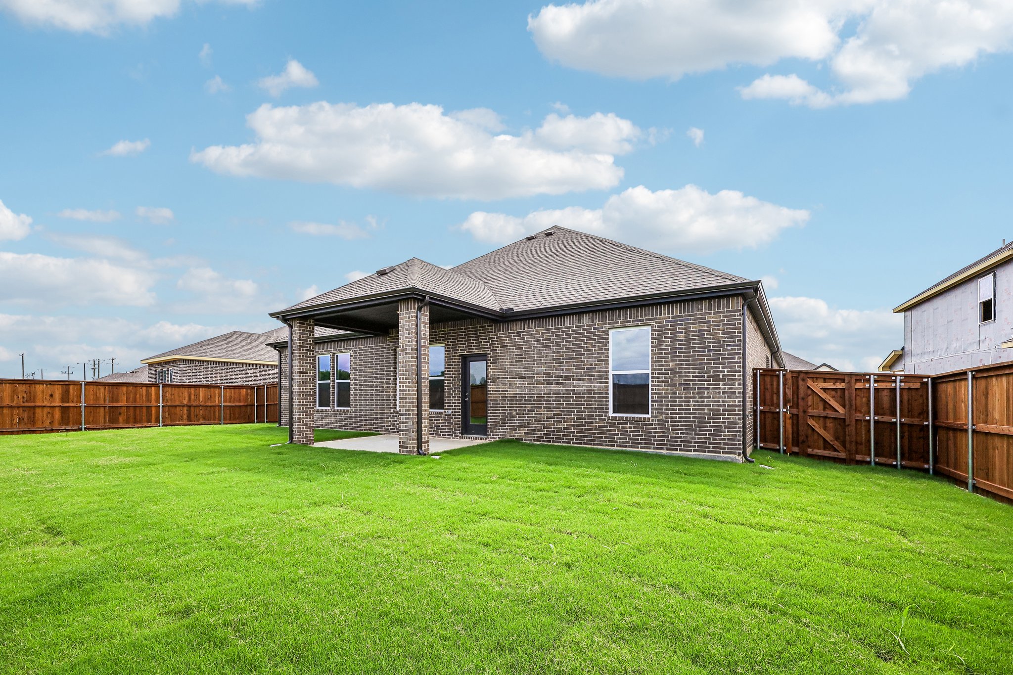 A brick house with a fence.