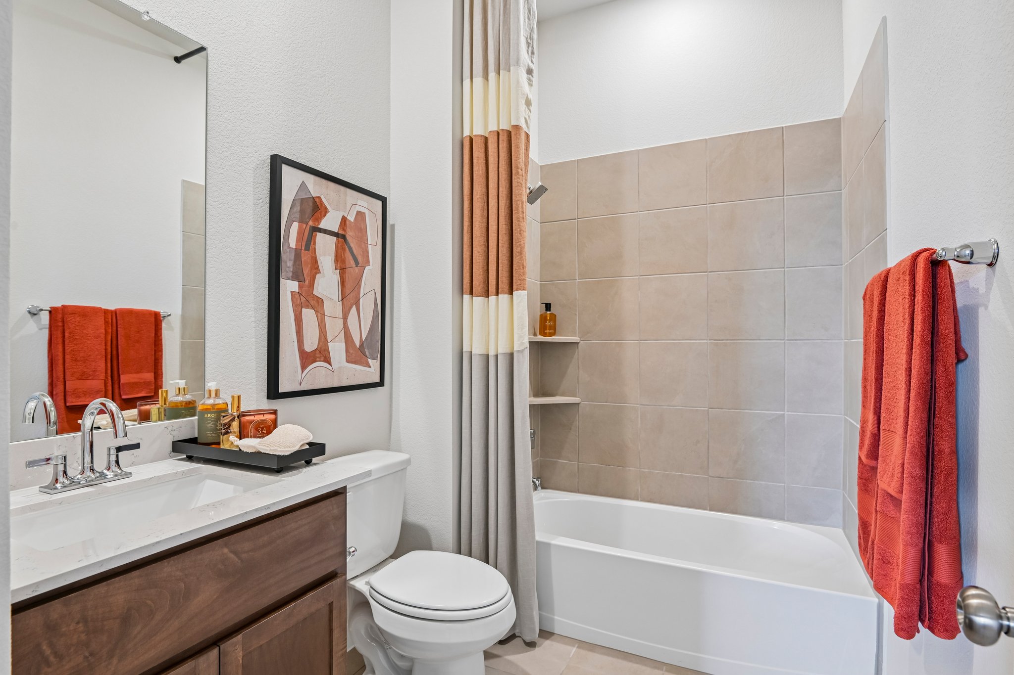 A bathroom with a tub toilet and sink.