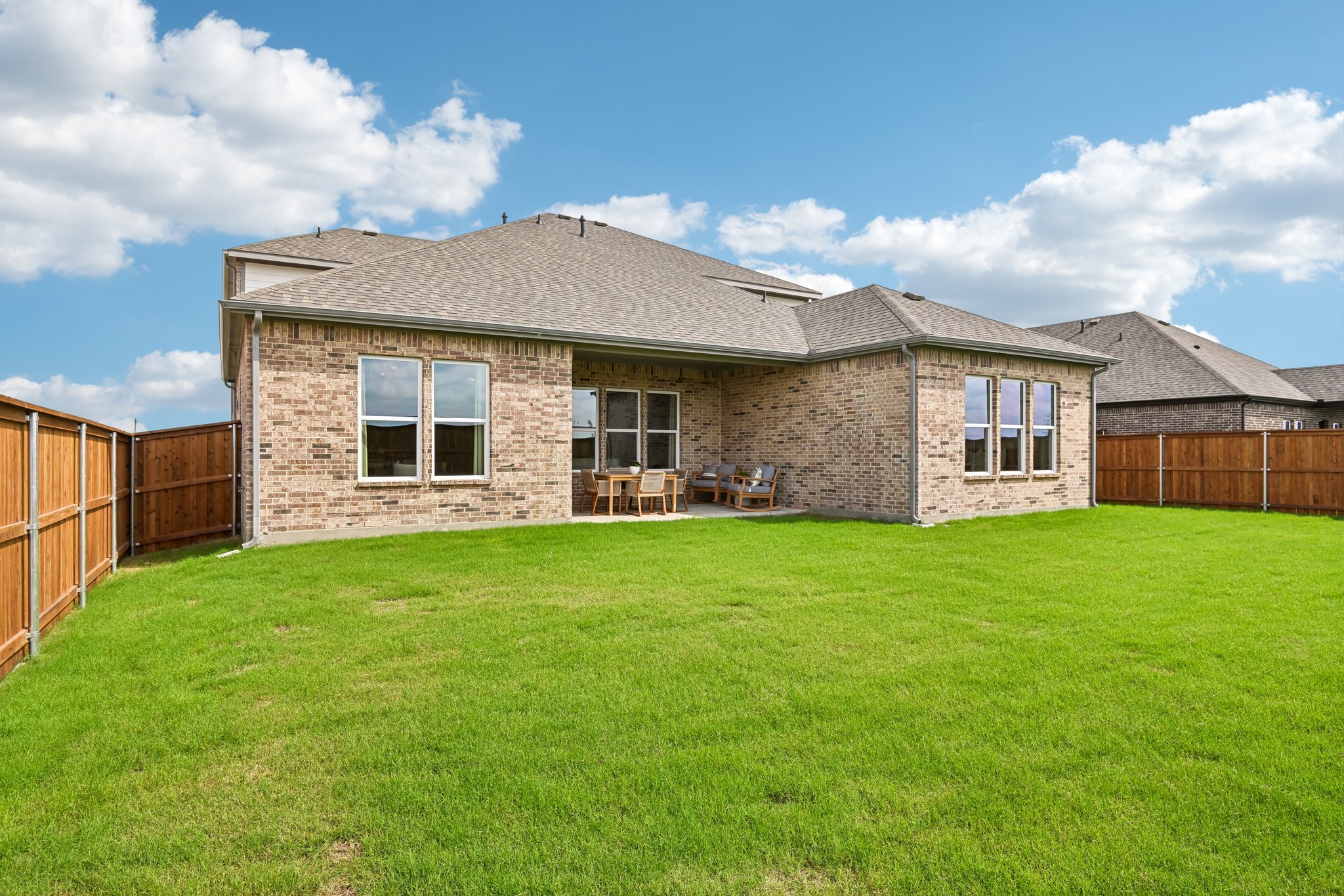 A house with a fence and grass.