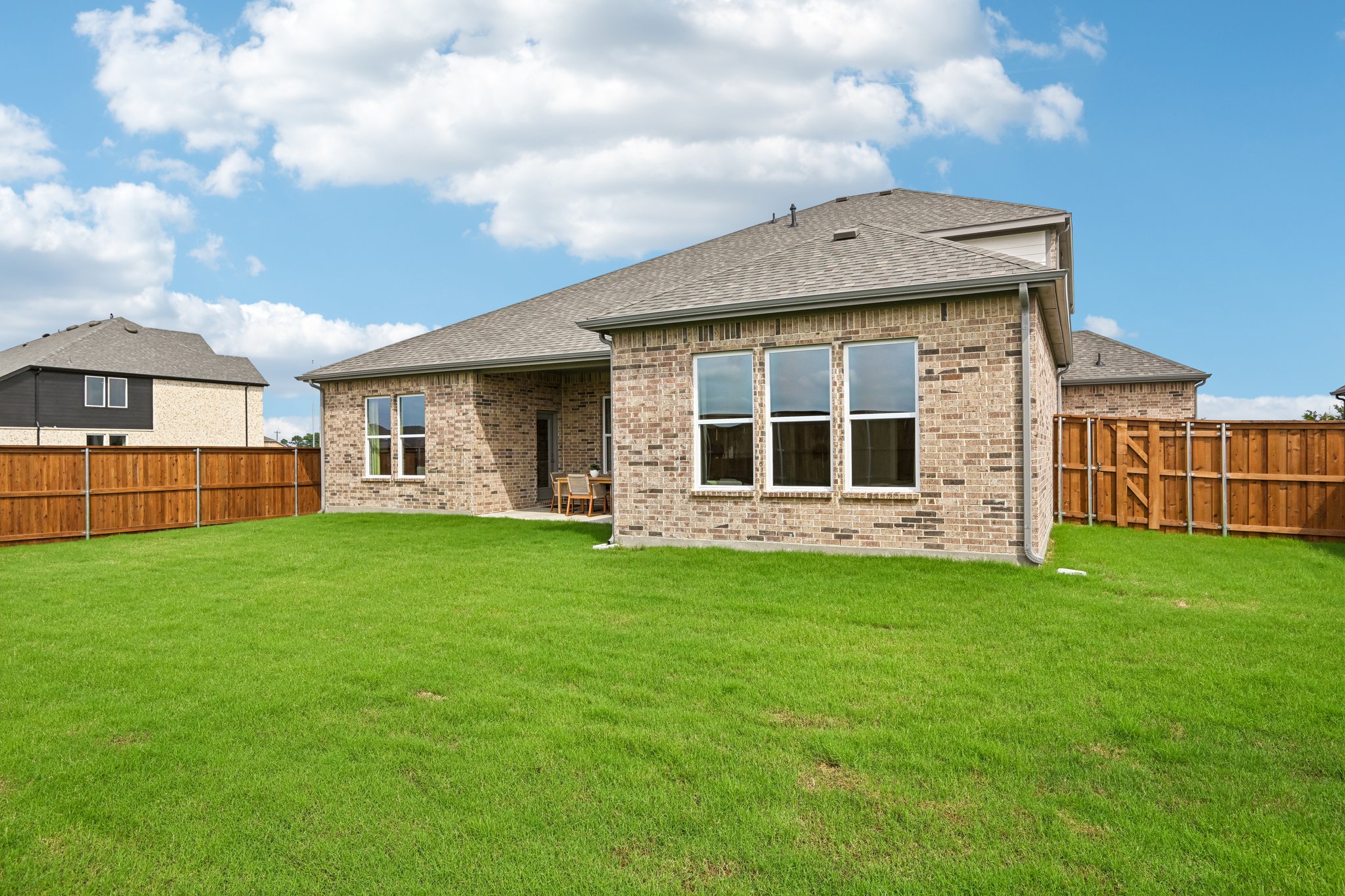 A house with a fence and grass.